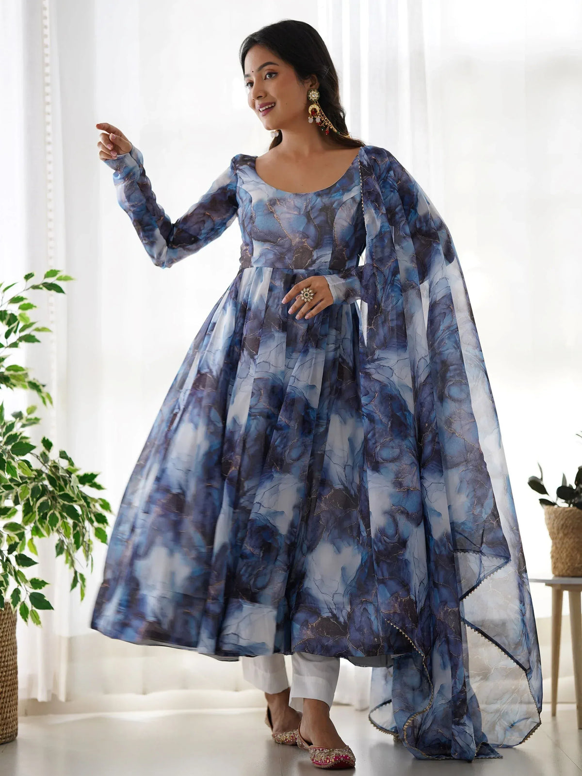 Blue marble print ethnic gown with flared skirt and dupatta, styled with white pants and juttis