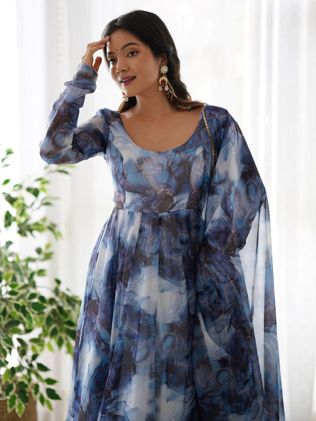 Blue marble print ethnic gown with gold accents, perfect for festive occasions and Indian celebrations.