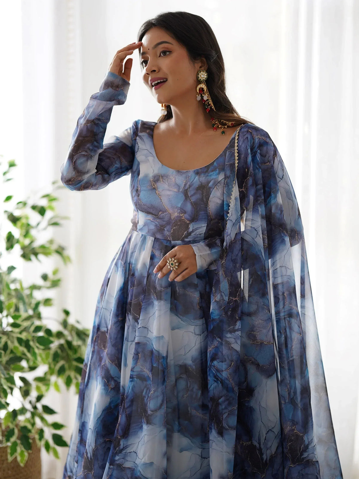 Blue marble print ethnic gown with gold detailing, perfect for Indian occasions and festive wear.