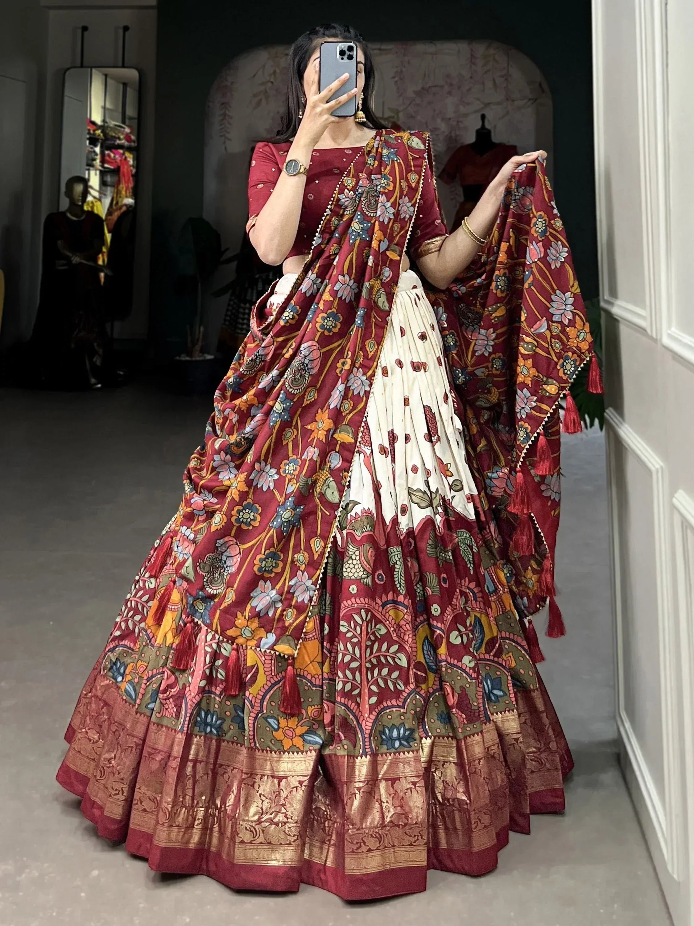 Woman in maroon floral lehenga choli with gold border, ethnic Indian wedding wear
