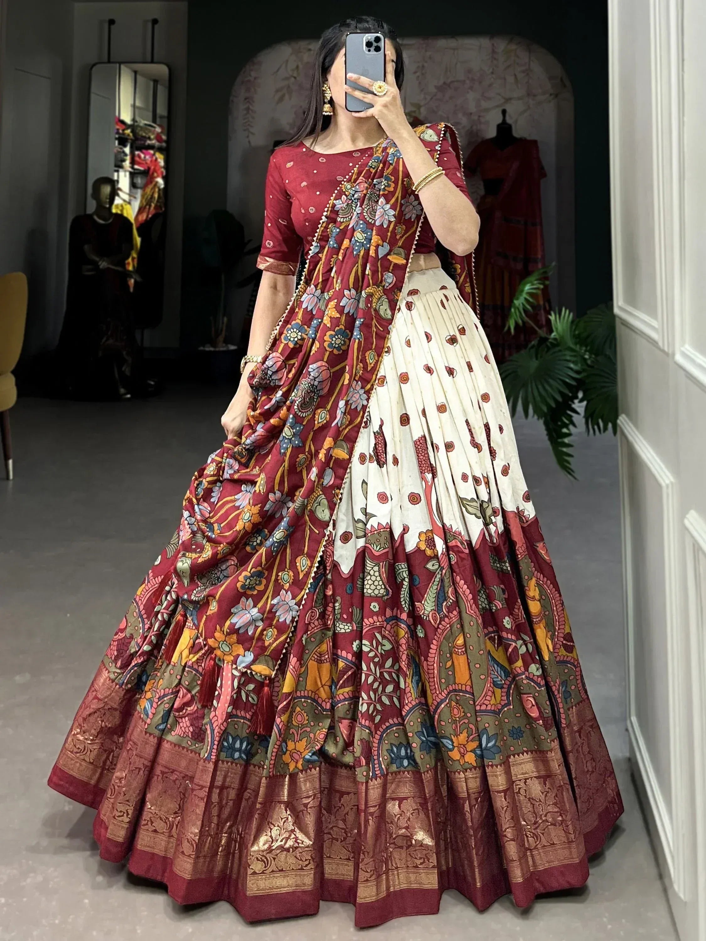 Woman in maroon floral lehenga choli with dupatta, ethnic Indian wear for weddings and festivals