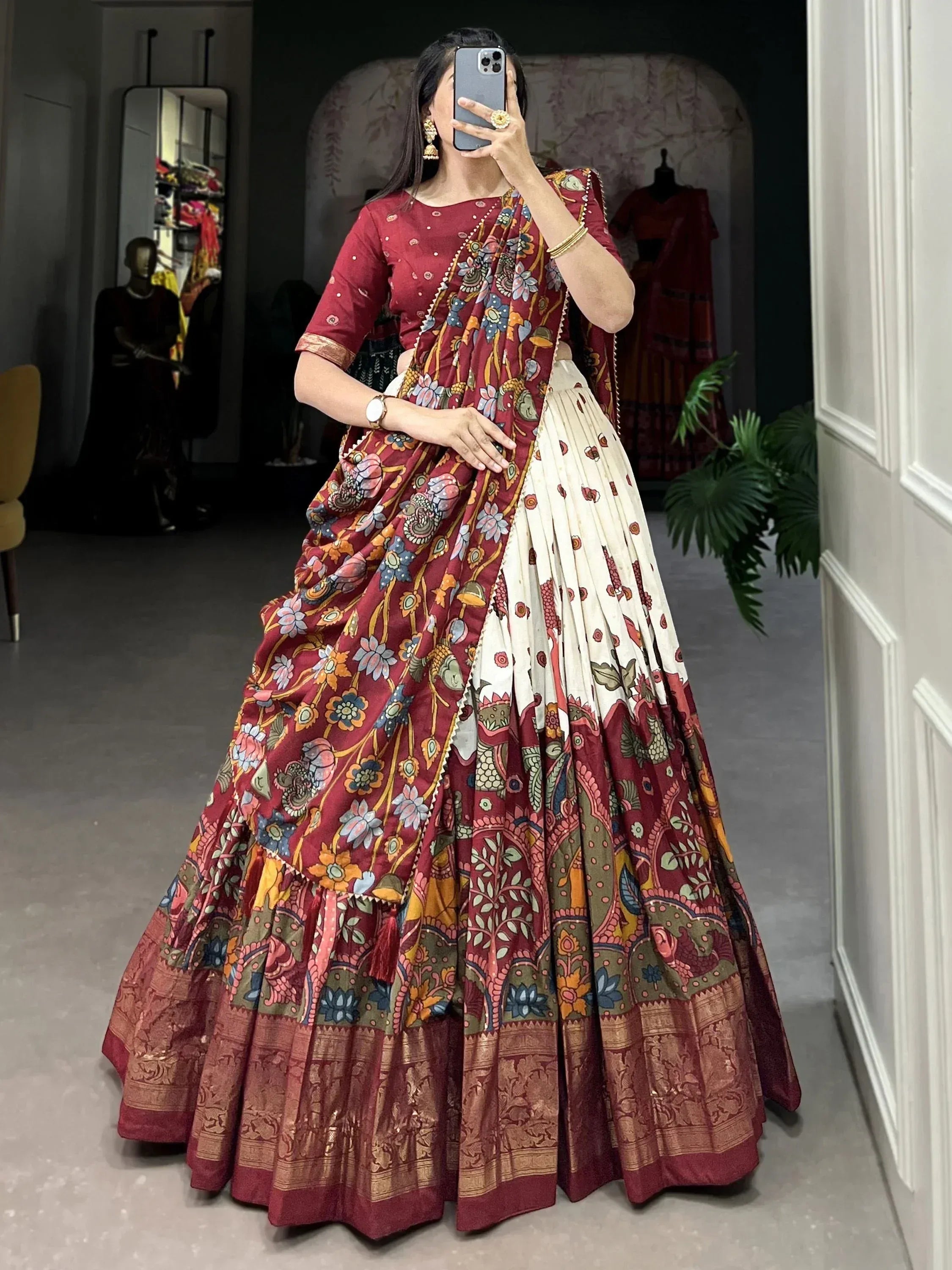 Elegant maroon floral lehenga choli with intricate patterns and golden border, perfect for Indian ethnic occasions.