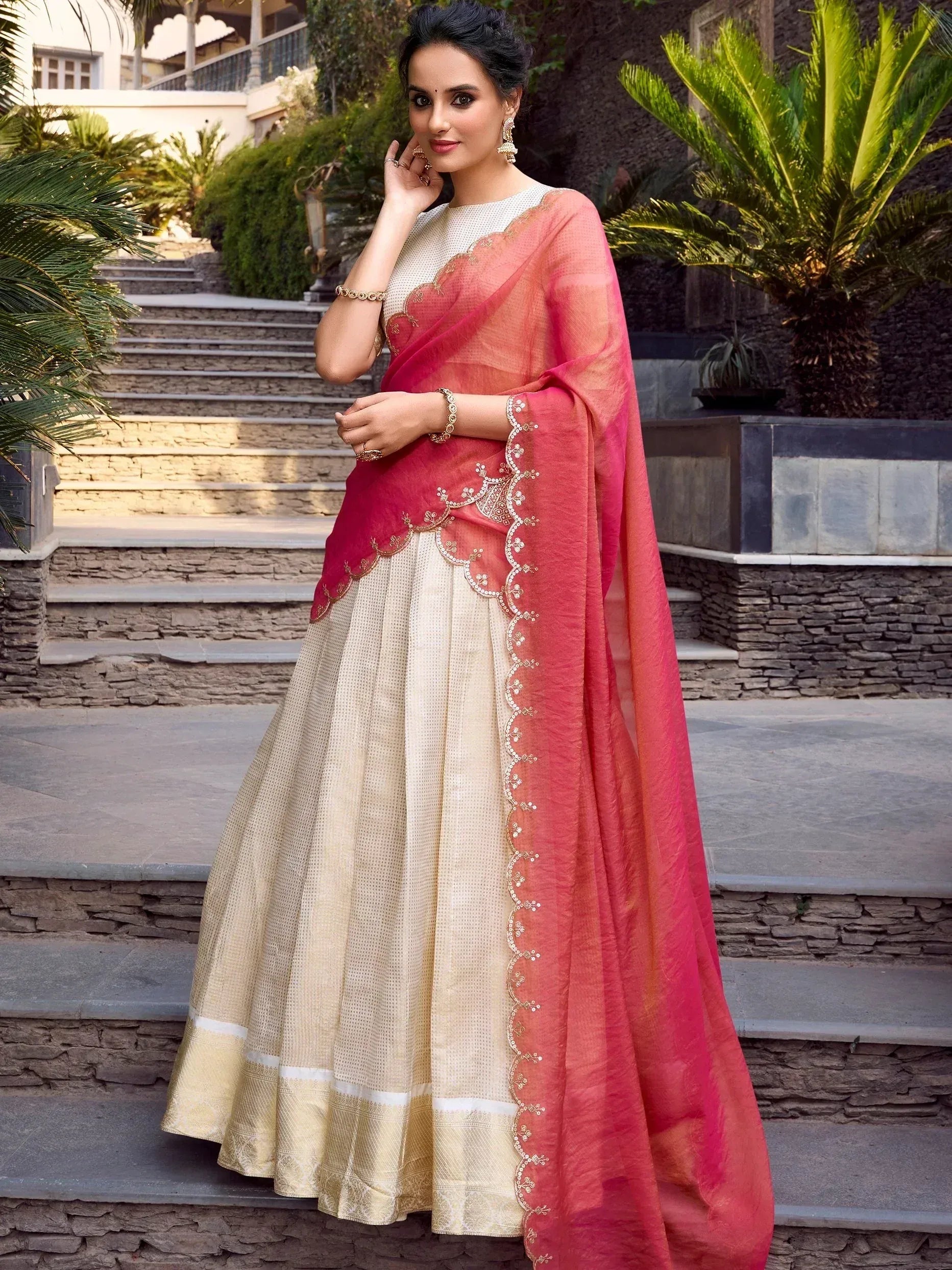 Elegant cream and pink embroidered lehenga choli with sheer dupatta, perfect for Indian ethnic occasions.