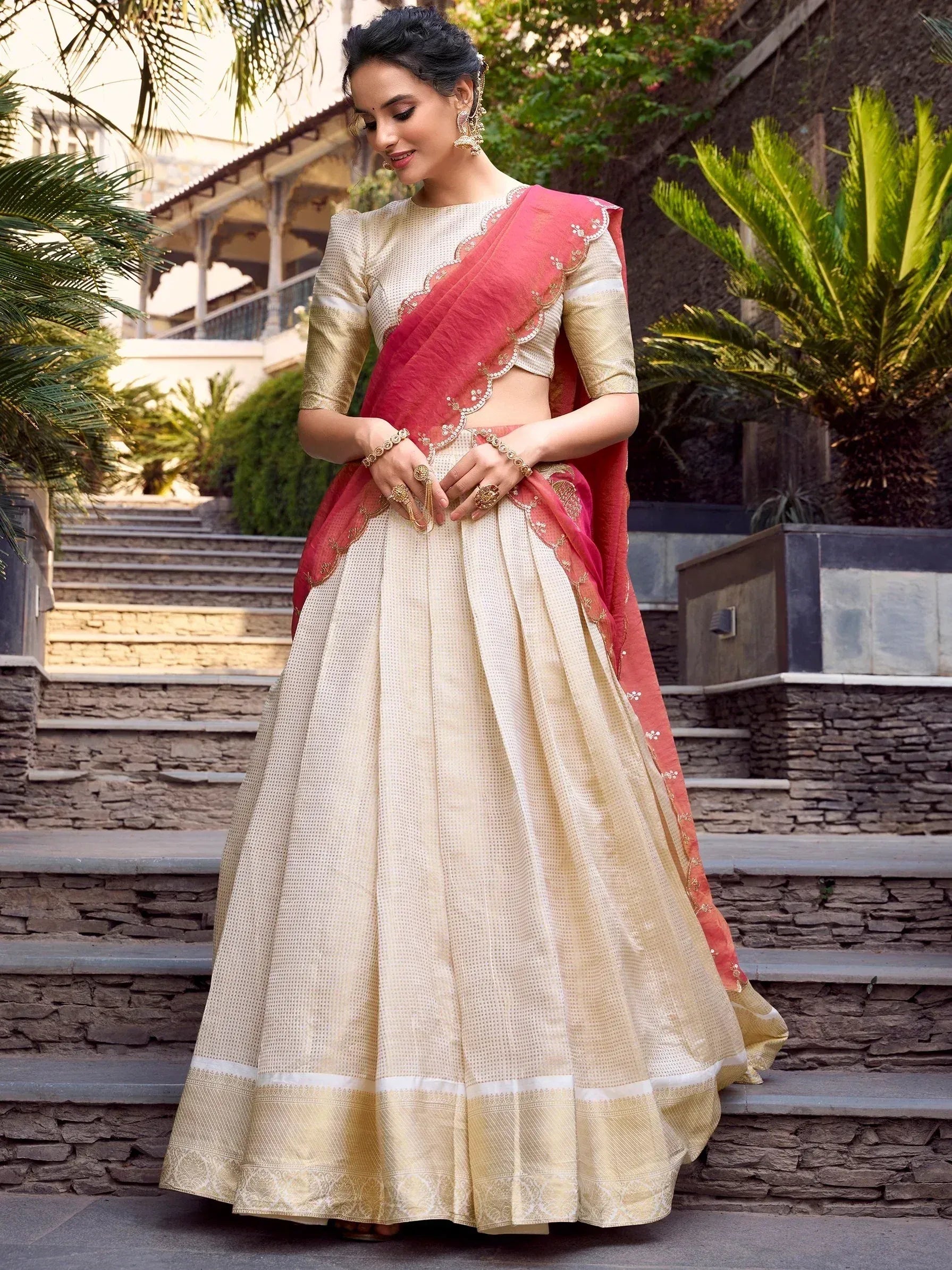 Elegant cream and pink lehenga choli with gold embroidery, perfect for Indian ethnic occasions