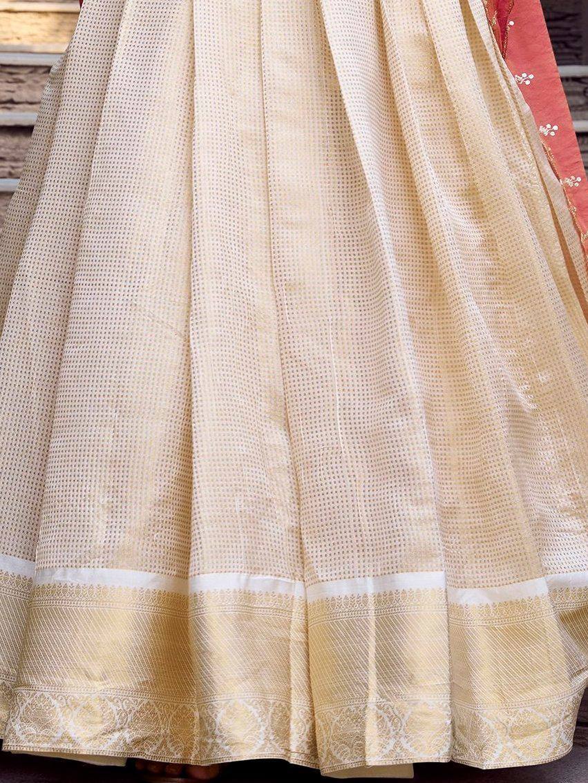 Cream ethnic lehenga skirt with woven dot pattern and embroidered border, perfect for Indian weddings.