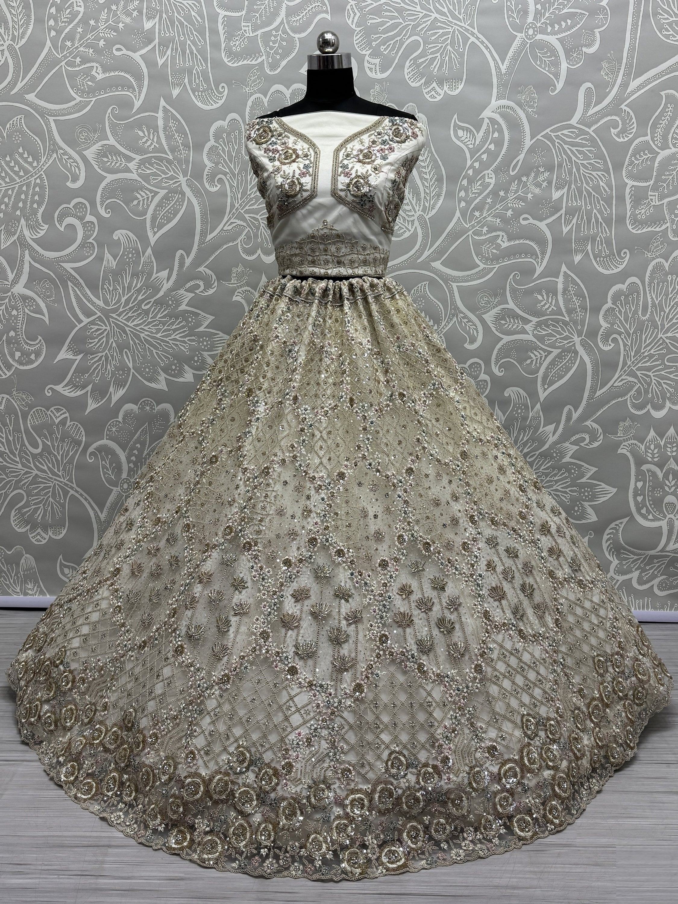 Elegant silver ethnic gown with heavy floral embroidery and sequin work, perfect for weddings and parties.