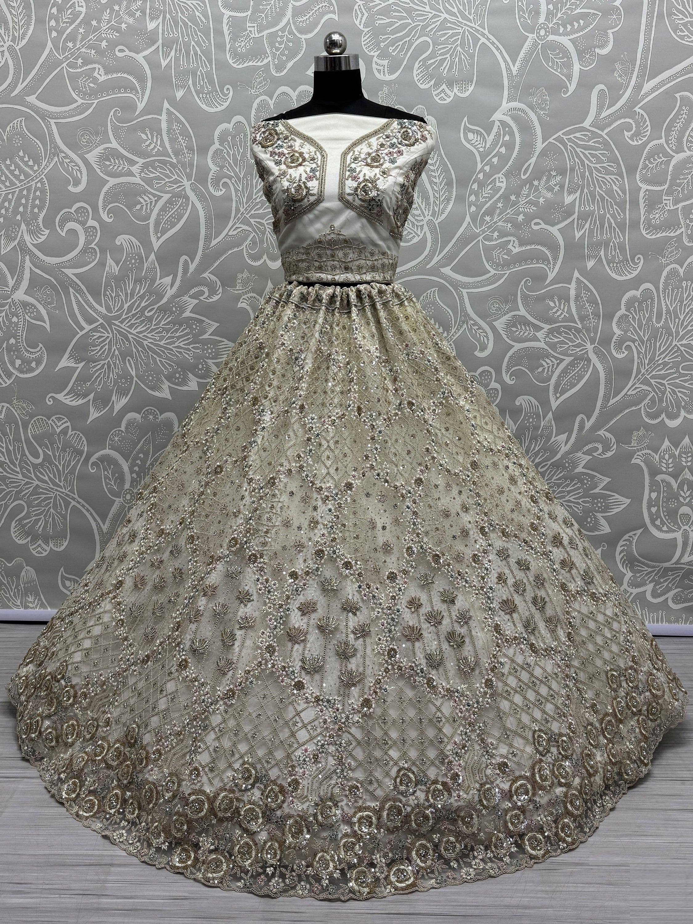 Elegant silver ethnic gown with heavy floral embroidery and sequin work, perfect for weddings and parties.