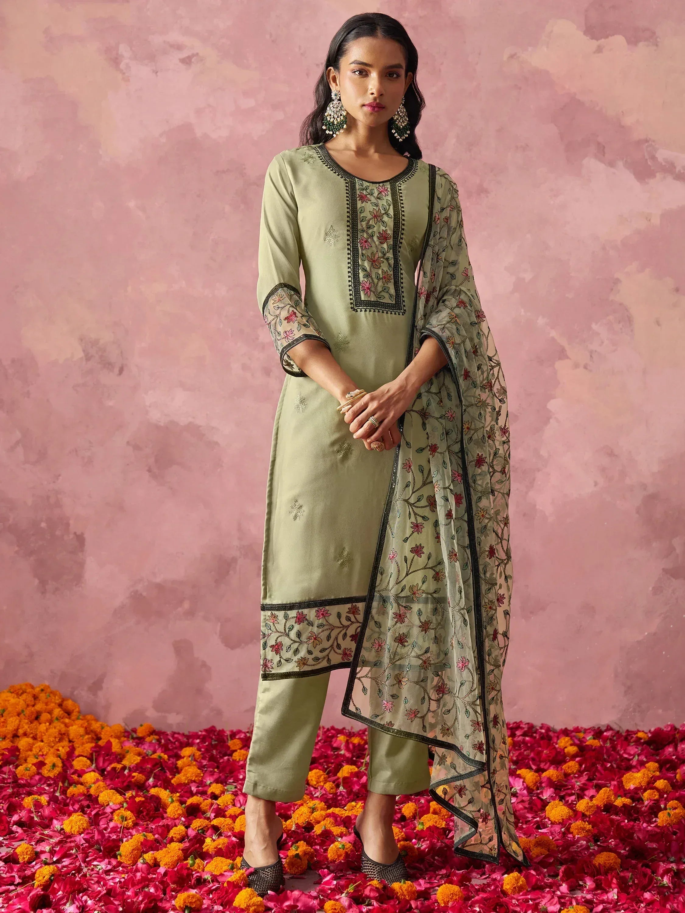 Elegant green embroidered salwar kameez with floral dupatta, perfect for festive occasions.