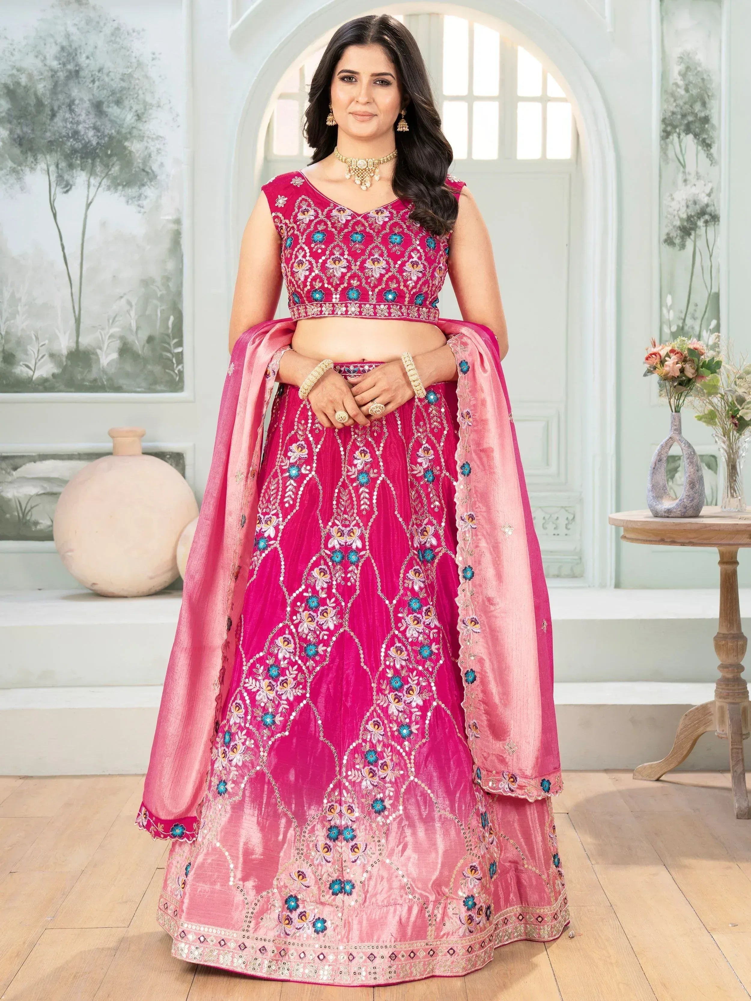Pink embroidered lehenga choli with floral motifs and matching dupatta, perfect for Indian ethnic wear occasions