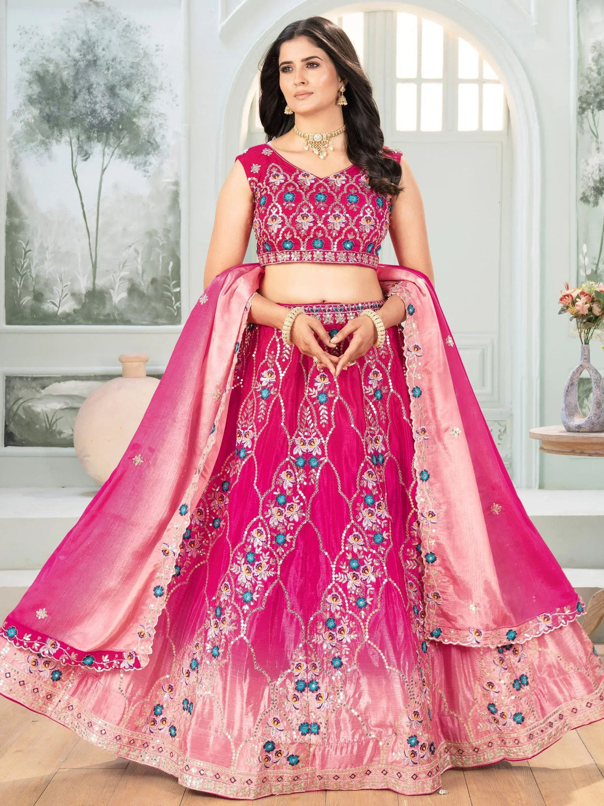 Pink embroidered lehenga choli with floral motifs and matching dupatta, perfect for Indian ethnic occasions