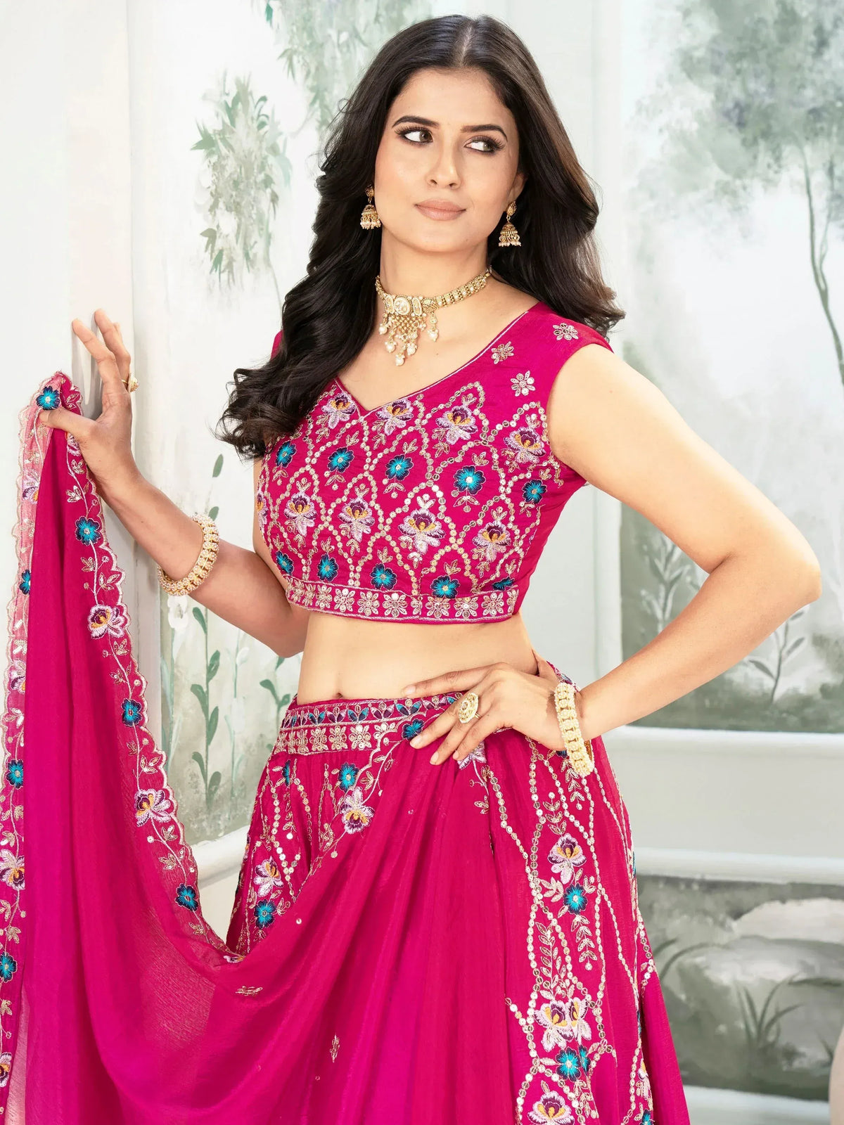 Pink embroidered lehenga choli with floral motifs, perfect for Indian ethnic wear occasions