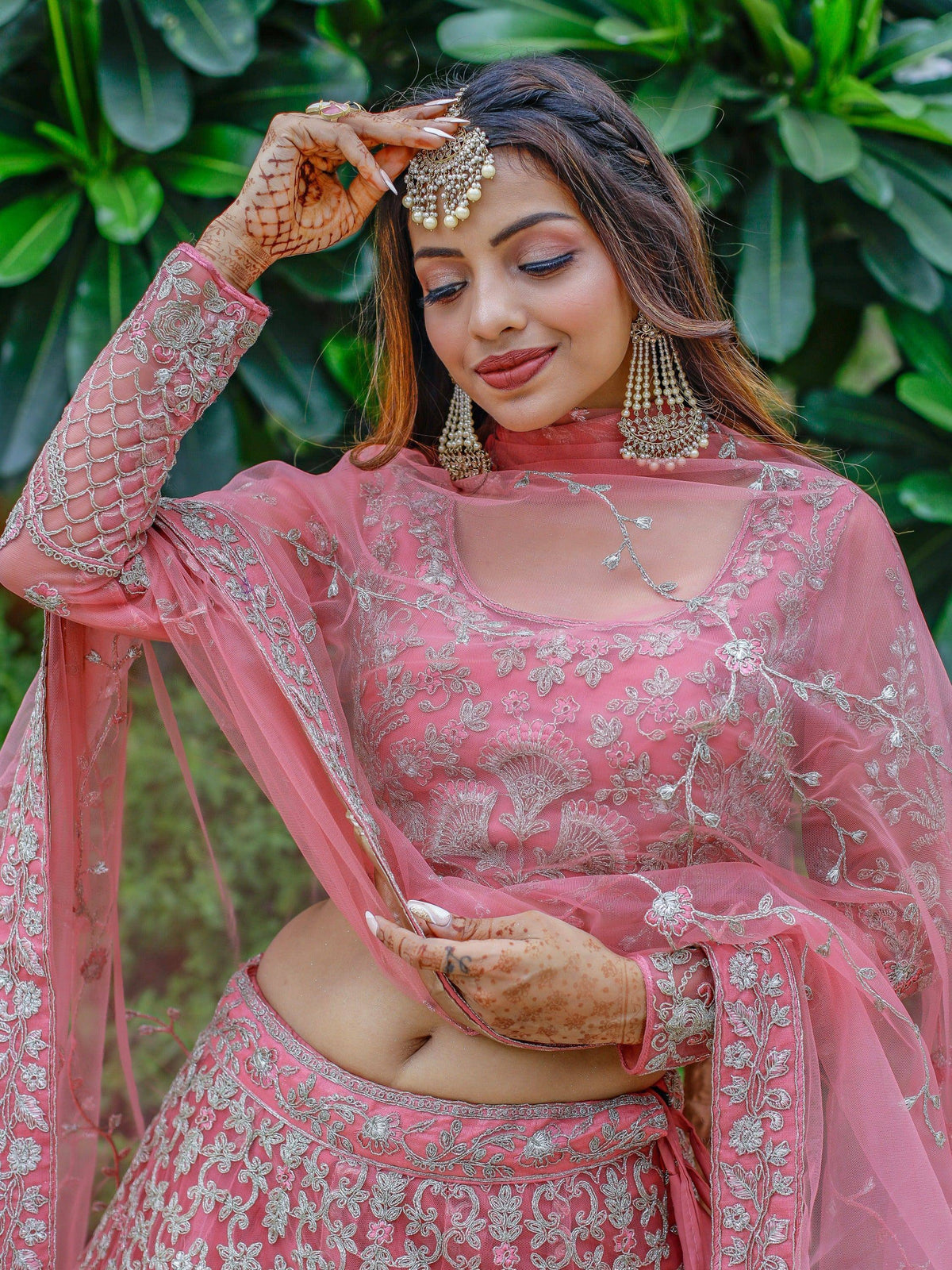 Pink embroidered lehenga choli with silver work, perfect for Indian weddings and festive occasions.