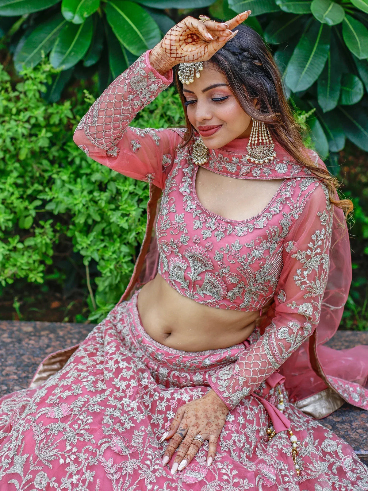 Pink embroidered lehenga choli with silver floral work, perfect for Indian weddings and festive occasions.