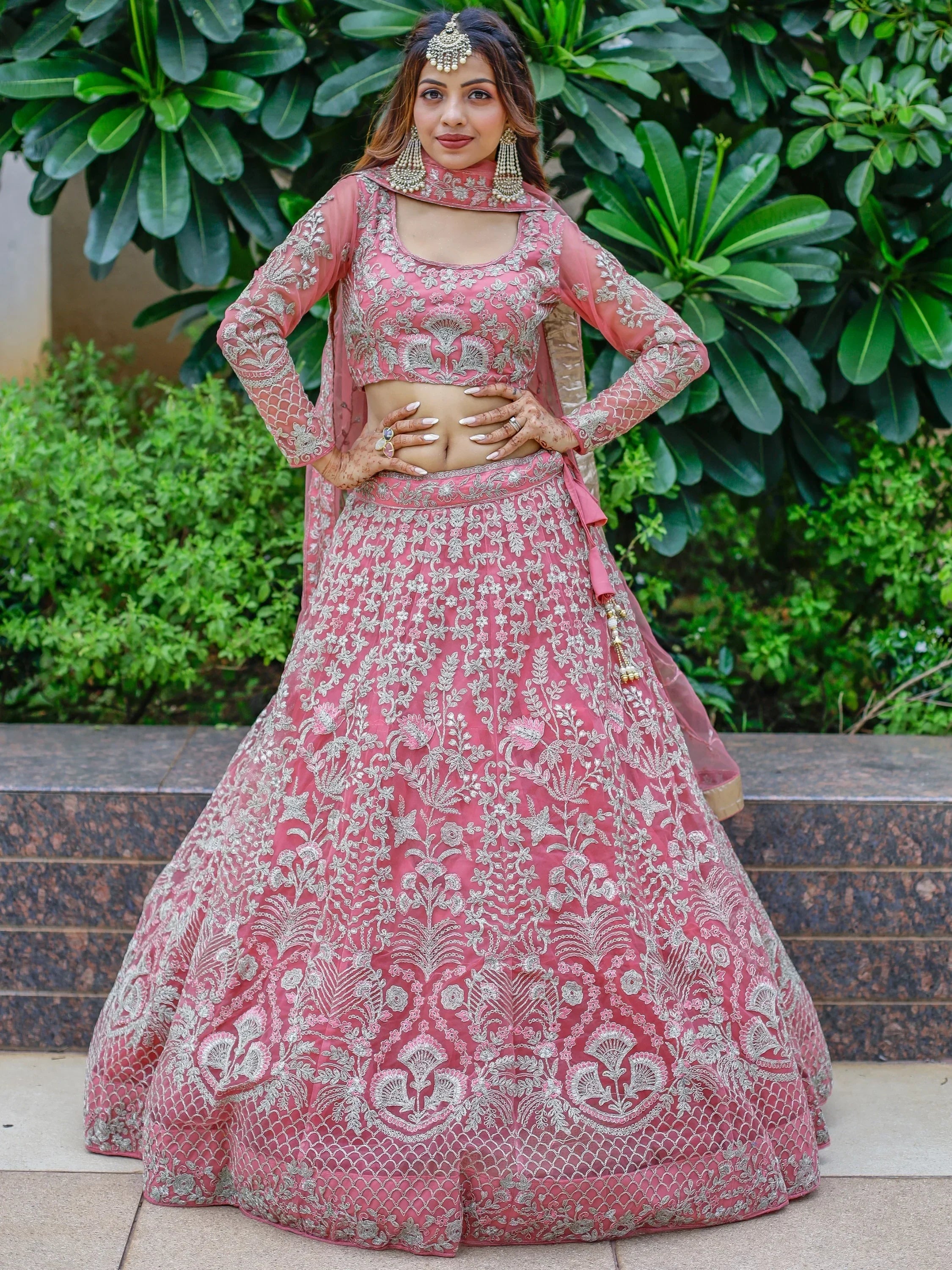 Pink embroidered lehenga choli with silver floral work, perfect for Indian weddings and festive occasions.