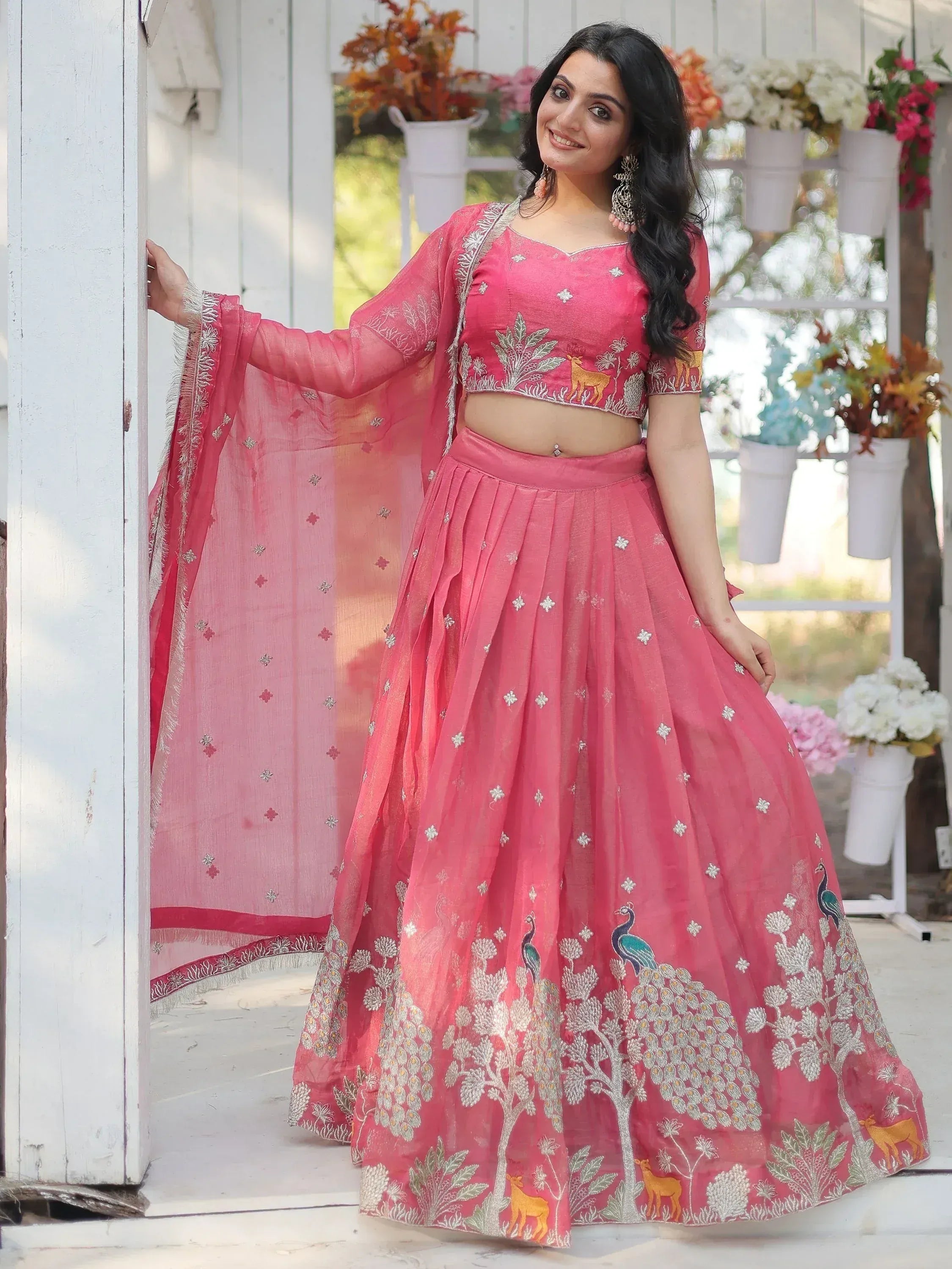 Pink embroidered lehenga choli with peacock and deer motifs, perfect for Indian ethnic wear occasions.