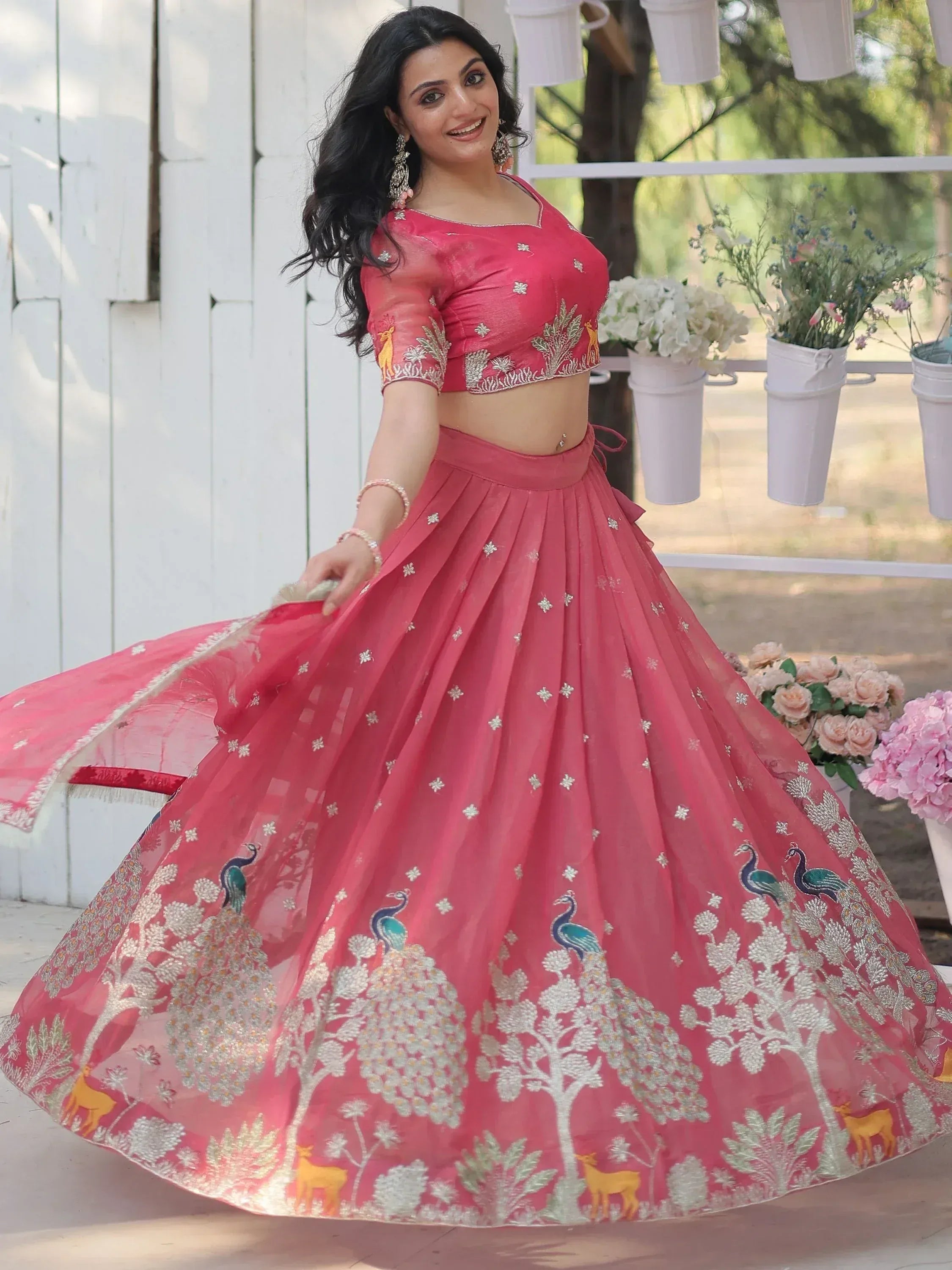 Pink embroidered lehenga choli with peacock and deer motifs, perfect for Indian ethnic wear occasions
