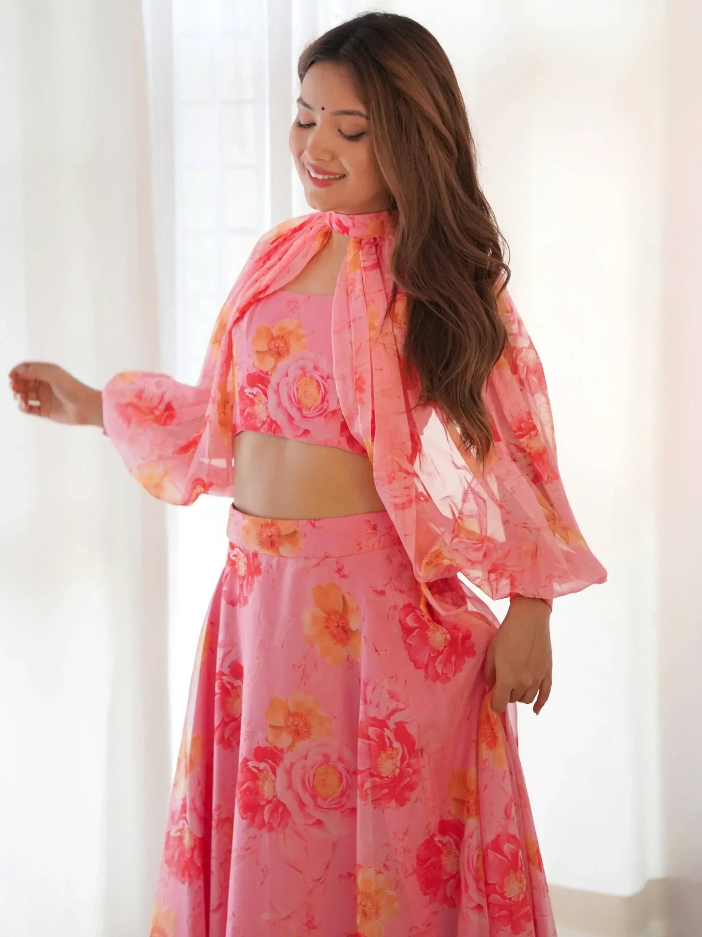 Pink floral lehenga choli with tie-neck top and flared skirt, perfect for ethnic occasions