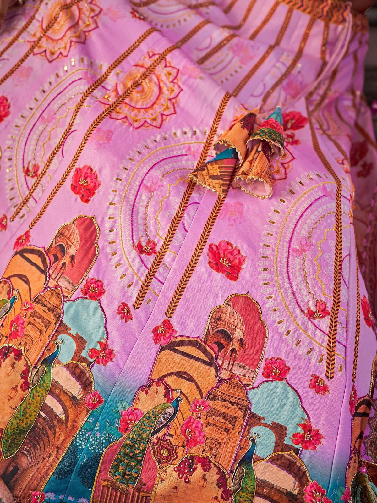 Pink Indian ethnic gown with peacock, temple print, floral embroidery, and tassels for festive occasions