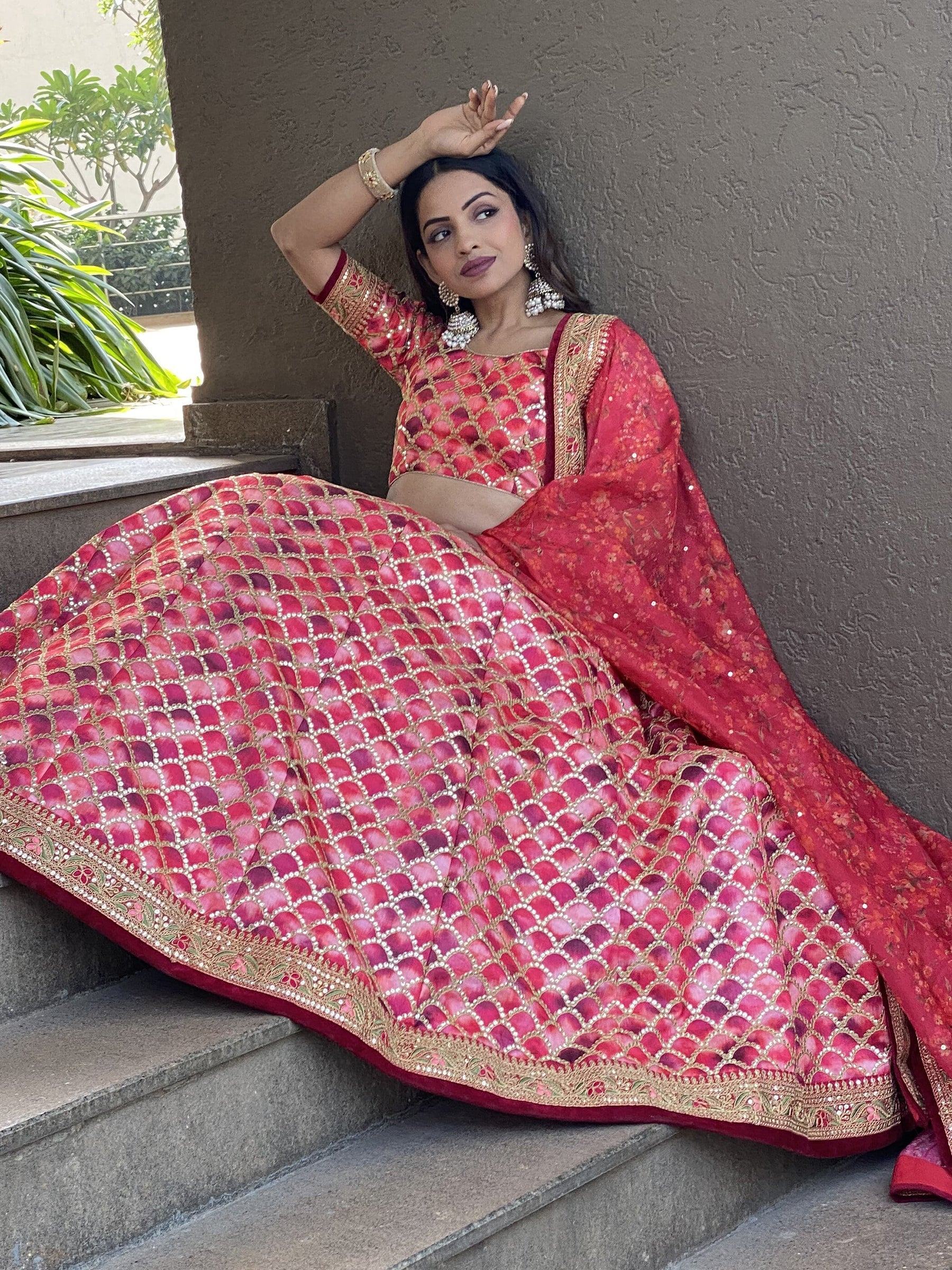 Red designer lehenga choli with gold embroidery, perfect for Indian weddings and festive occasions.