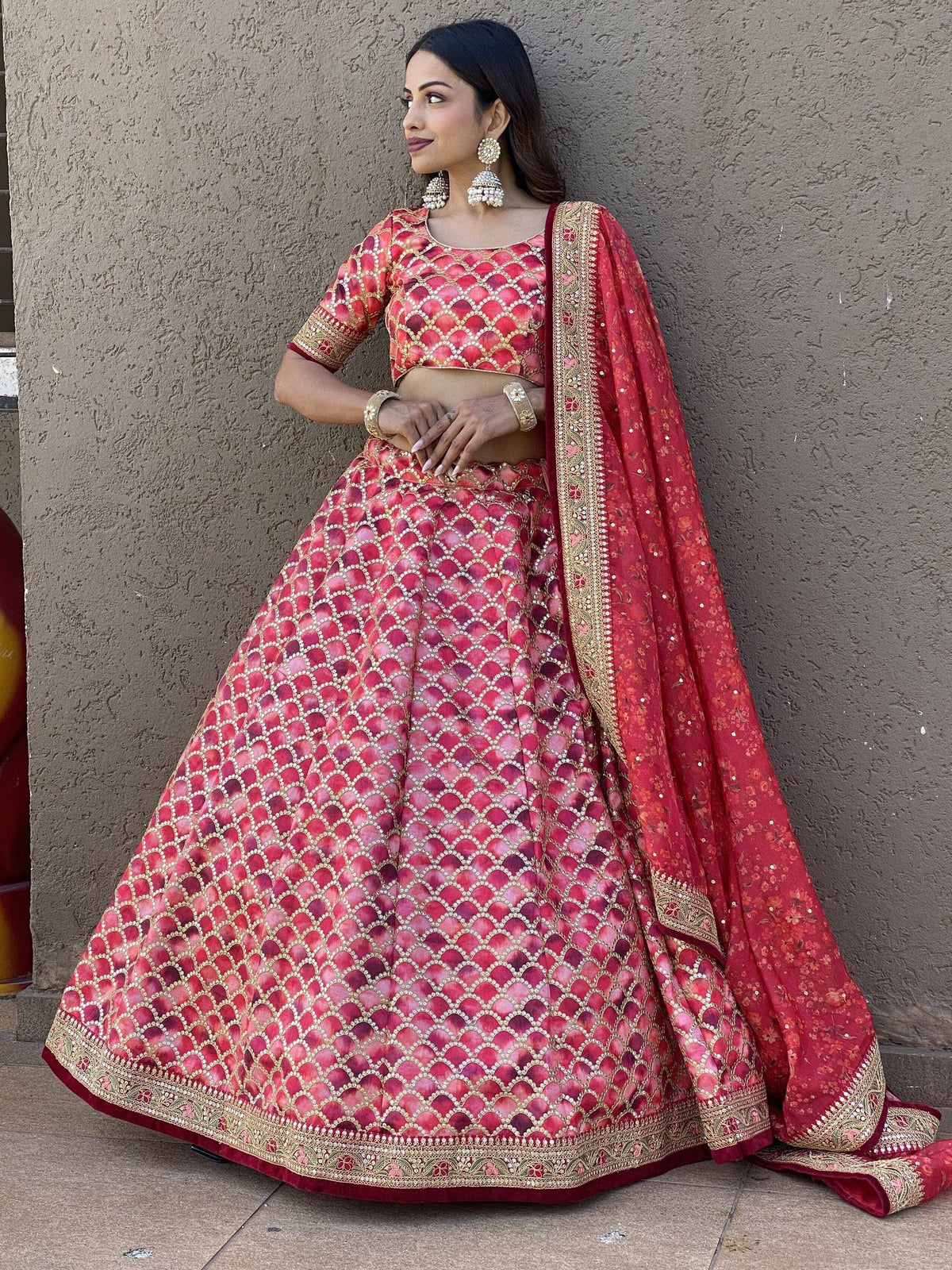 Red designer lehenga choli with gold embroidery and scalloped pattern, perfect for Indian weddings and festivals