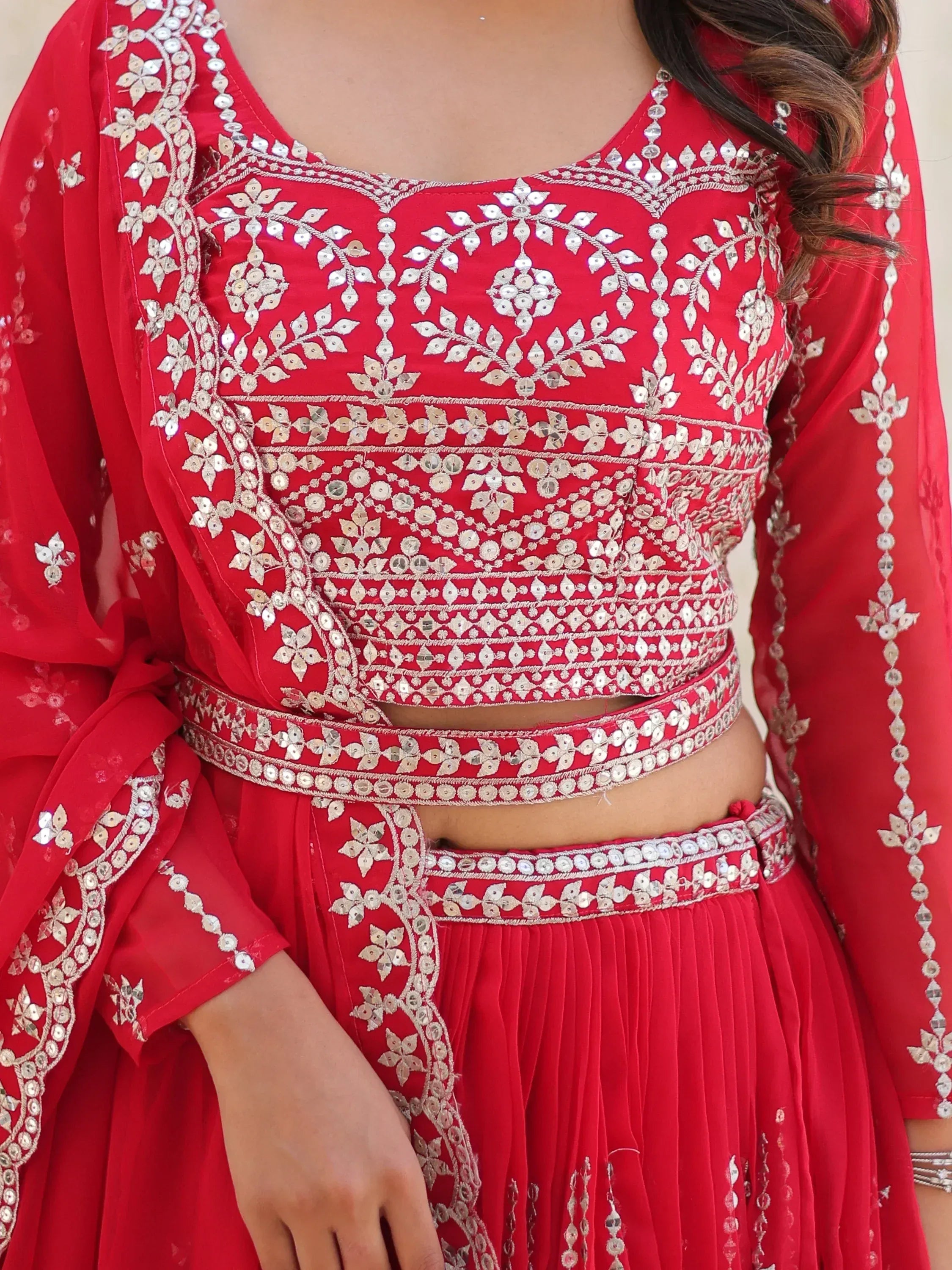 Red designer lehenga choli with intricate mirror and thread embroidery, perfect for Indian ethnic wear