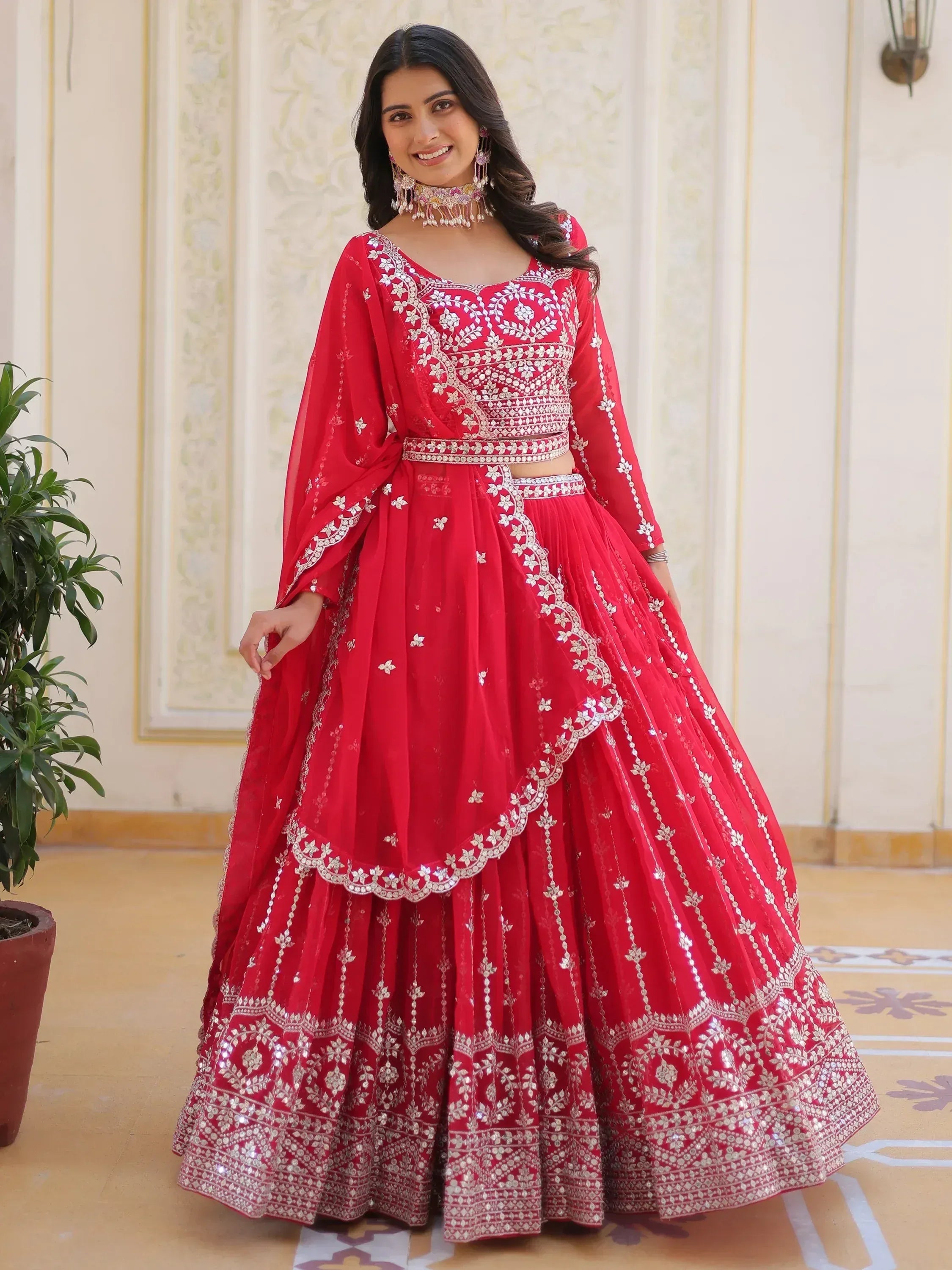 Red embroidered lehenga choli with silver mirror work, perfect for Indian weddings and festive occasions