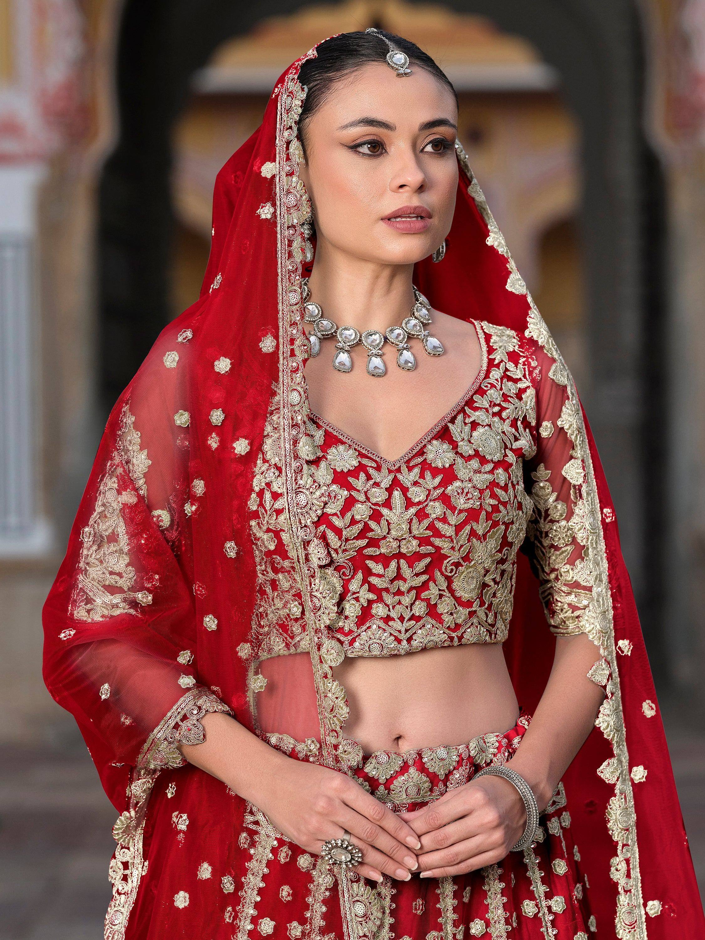 Red and gold embroidered lehenga choli with dupatta, traditional Indian bridal wear