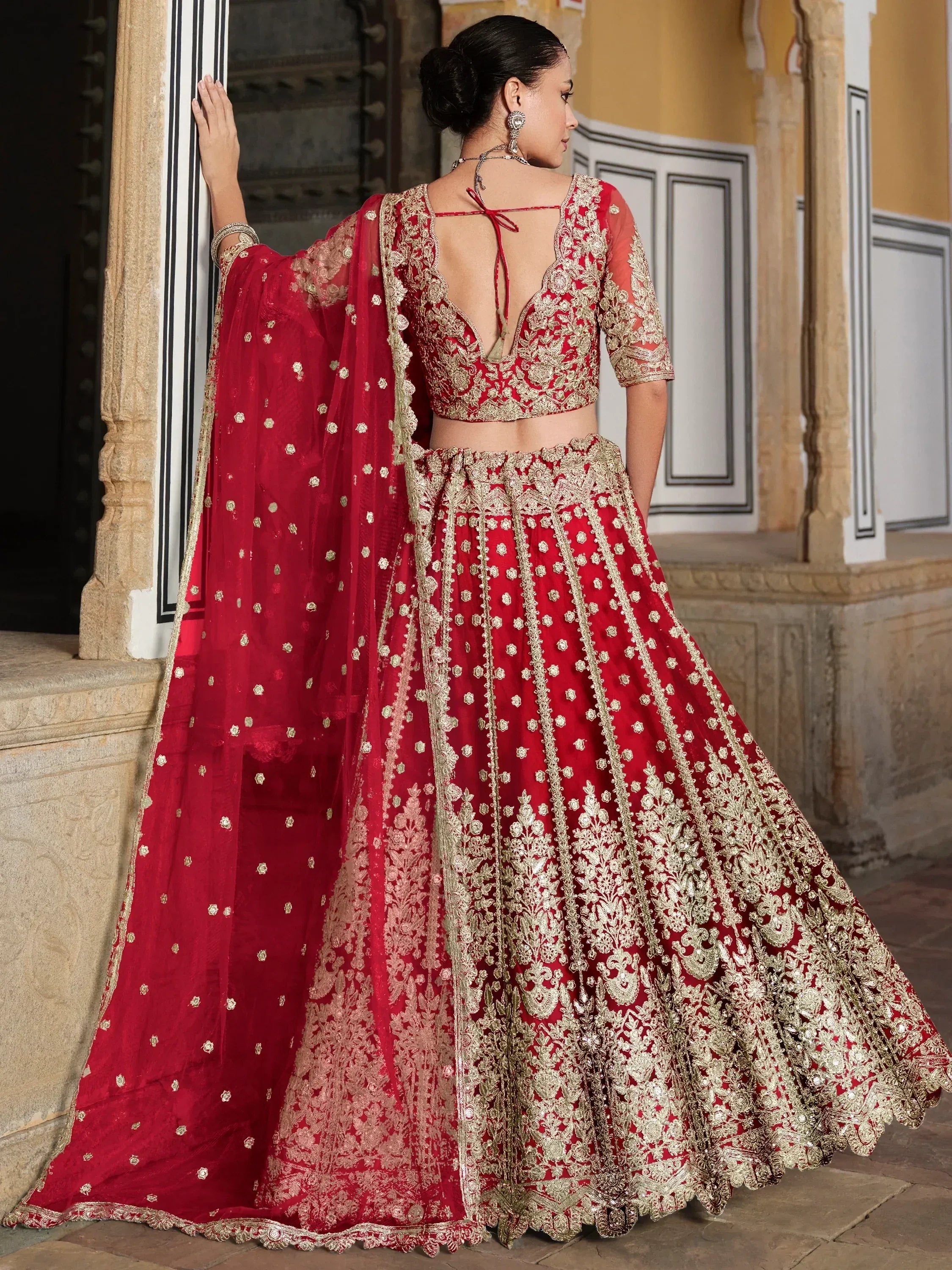 Red and gold embroidered lehenga choli with sheer dupatta, back view, Indian ethnic wear