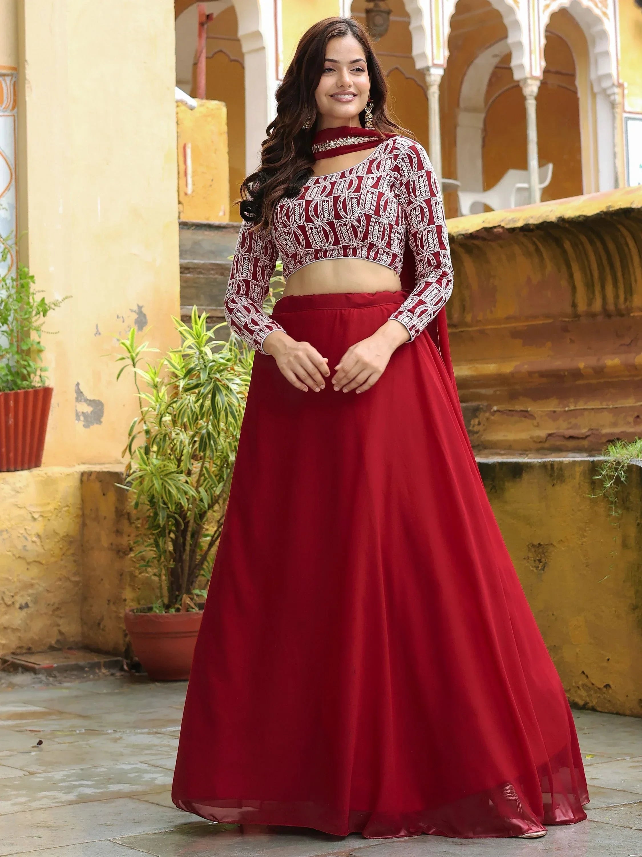 Red embroidered lehenga choli with long sleeves, perfect for Indian ethnic wear and festive occasions