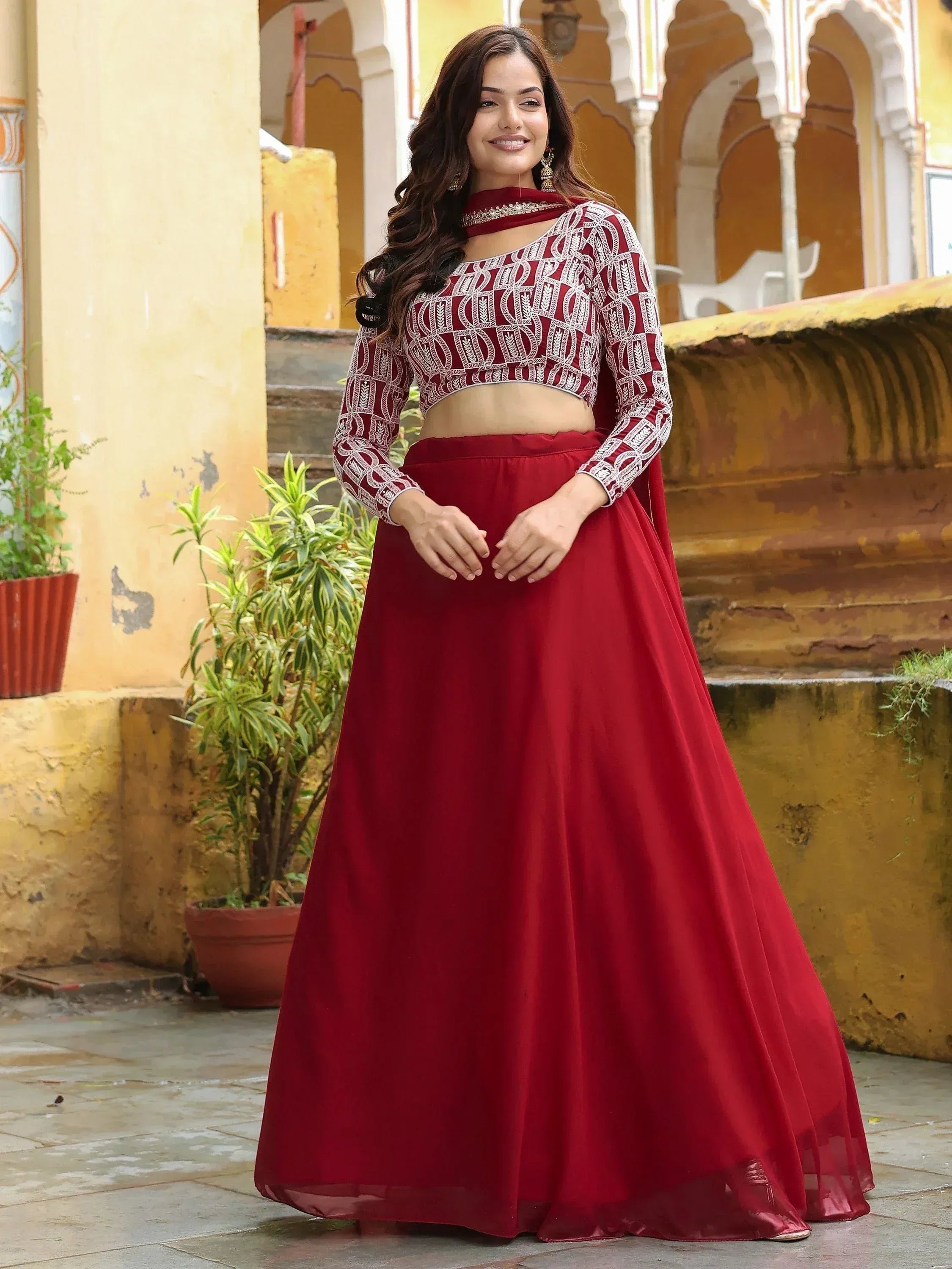 Red embroidered lehenga choli with long sleeves, perfect for Indian ethnic wear and festive occasions