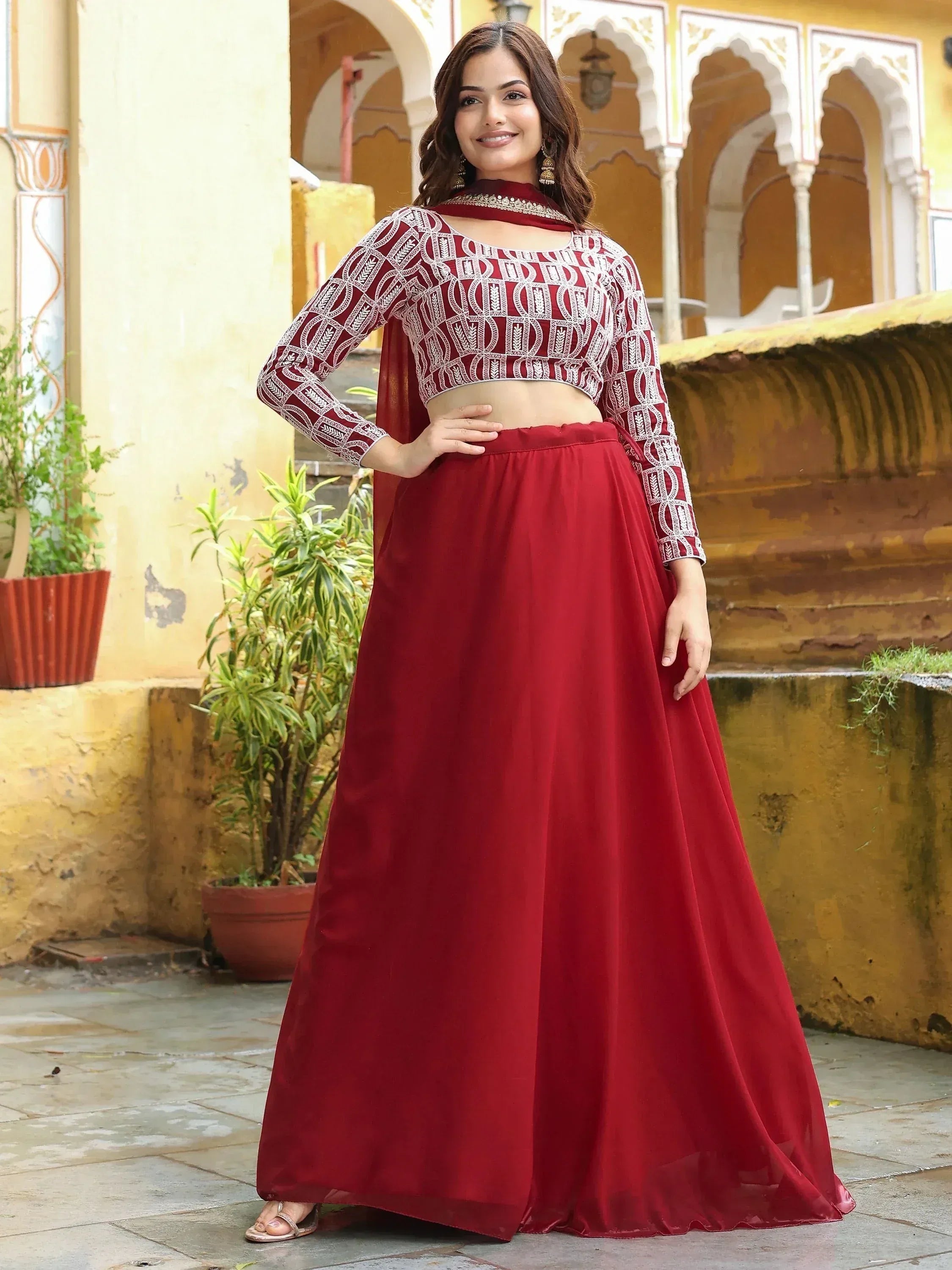 Maroon embroidered lehenga choli with long sleeves, perfect for Indian ethnic wear and festive occasions.