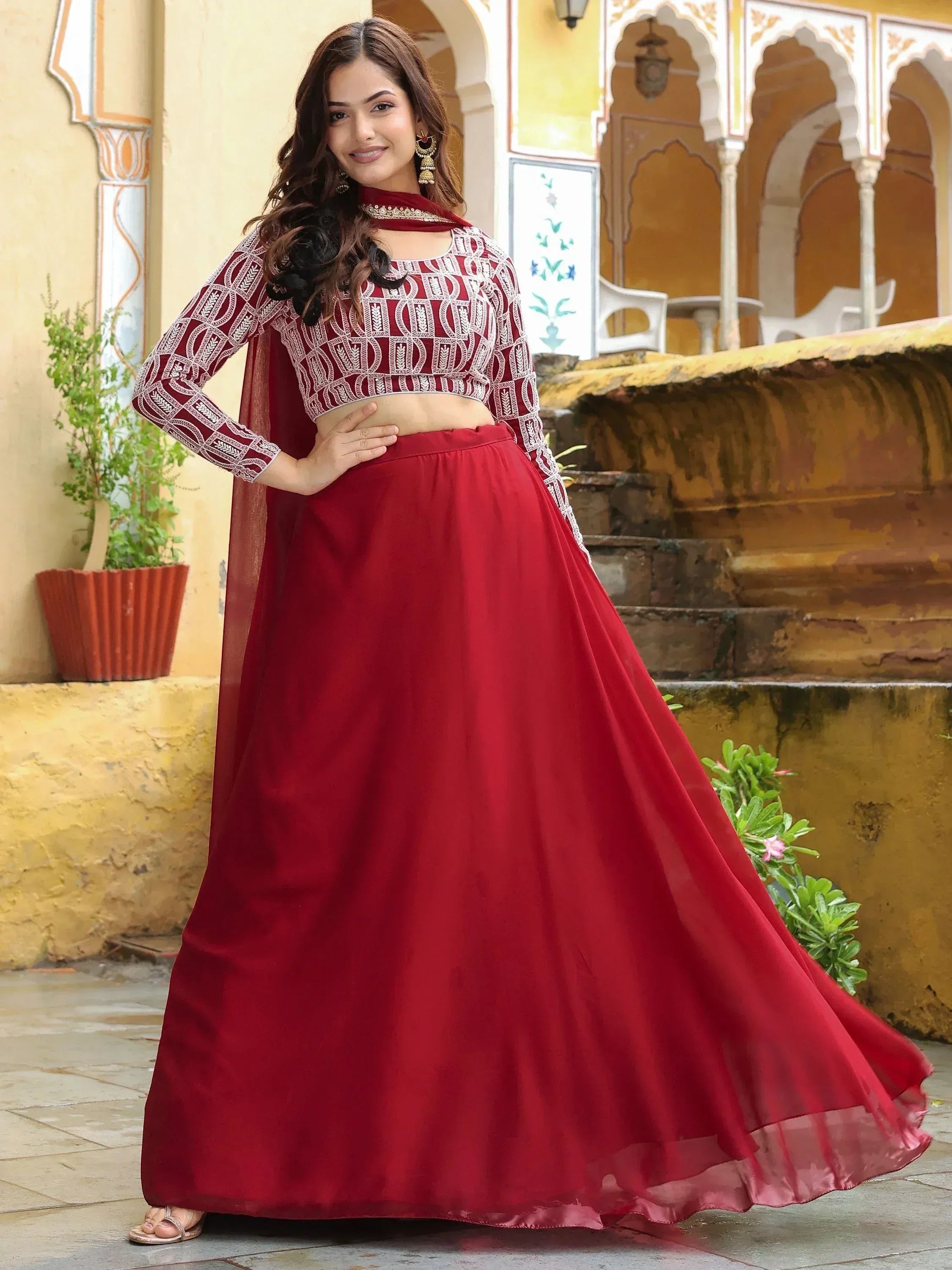 Woman in maroon embroidered lehenga choli with dupatta, traditional Indian ethnic wear