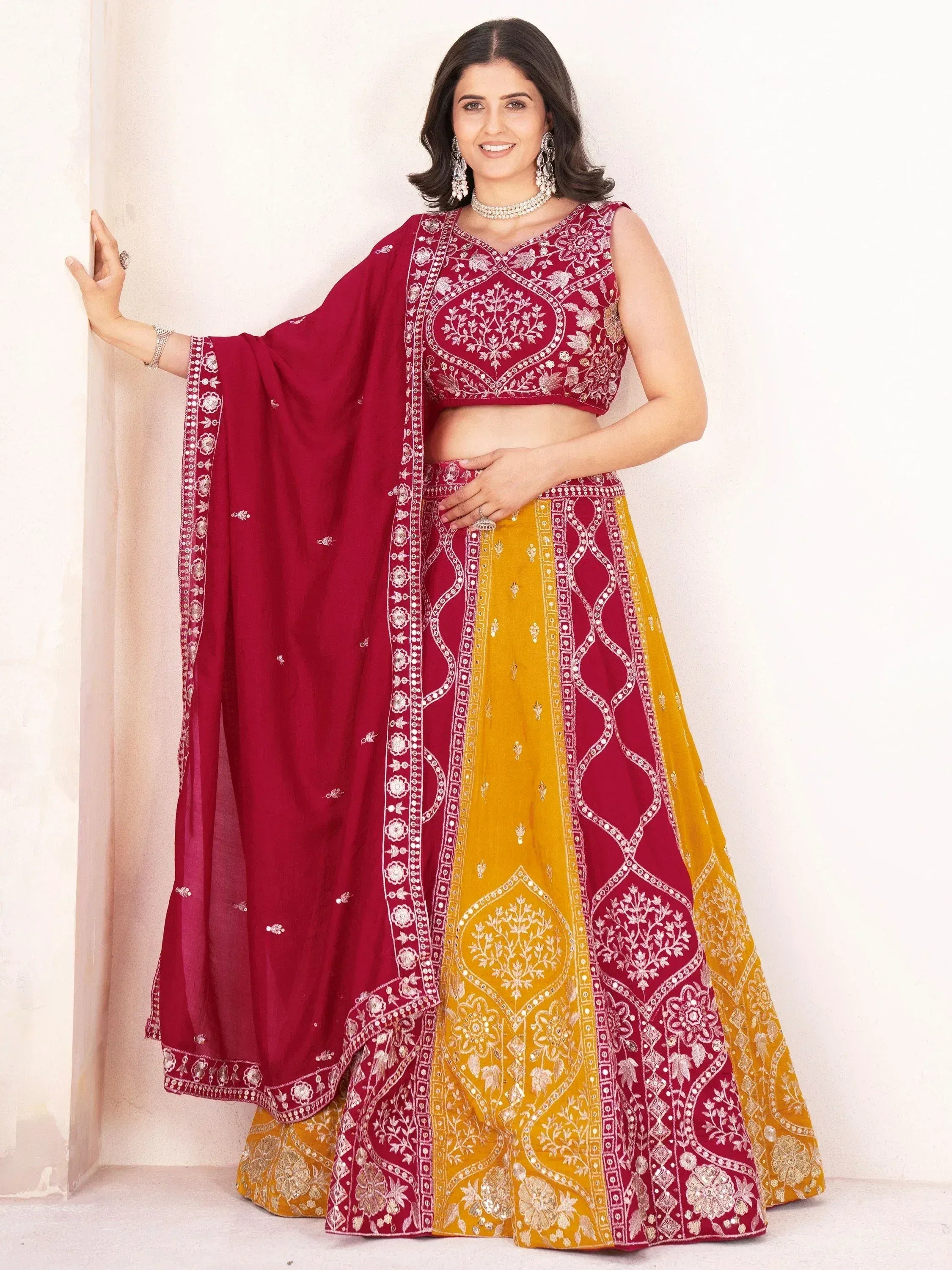Maroon and yellow embroidered lehenga choli with floral motifs, perfect for Indian ethnic wear occasions.