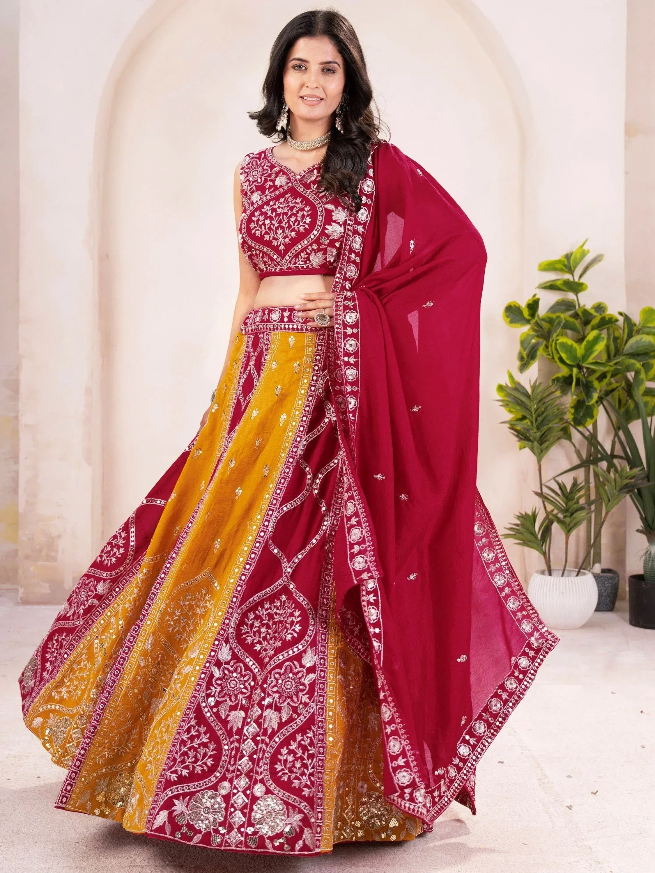 Maroon and mustard embroidered lehenga choli with floral motifs and dupatta, perfect for Indian ethnic occasions.