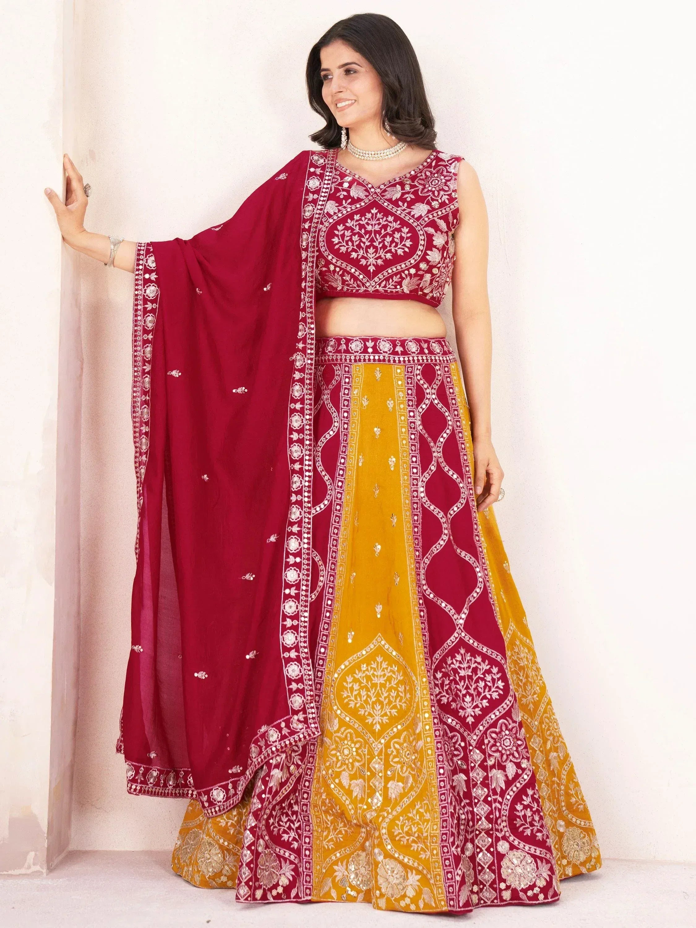 Maroon and yellow embroidered lehenga choli with floral motifs, perfect for Indian ethnic wear occasions.