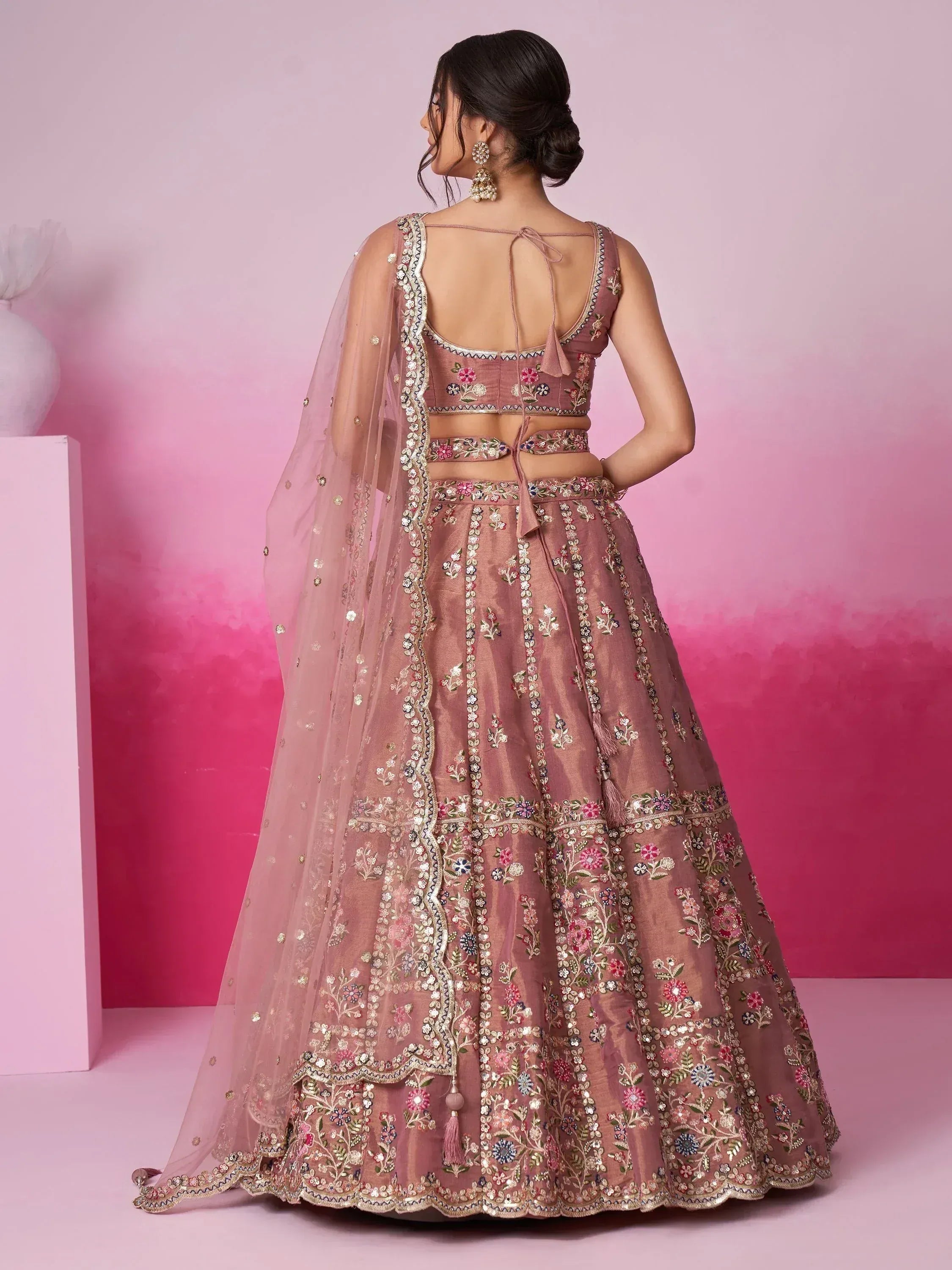 Pink embroidered lehenga choli with floral motifs and sheer dupatta, ideal for Indian ethnic wear occasions