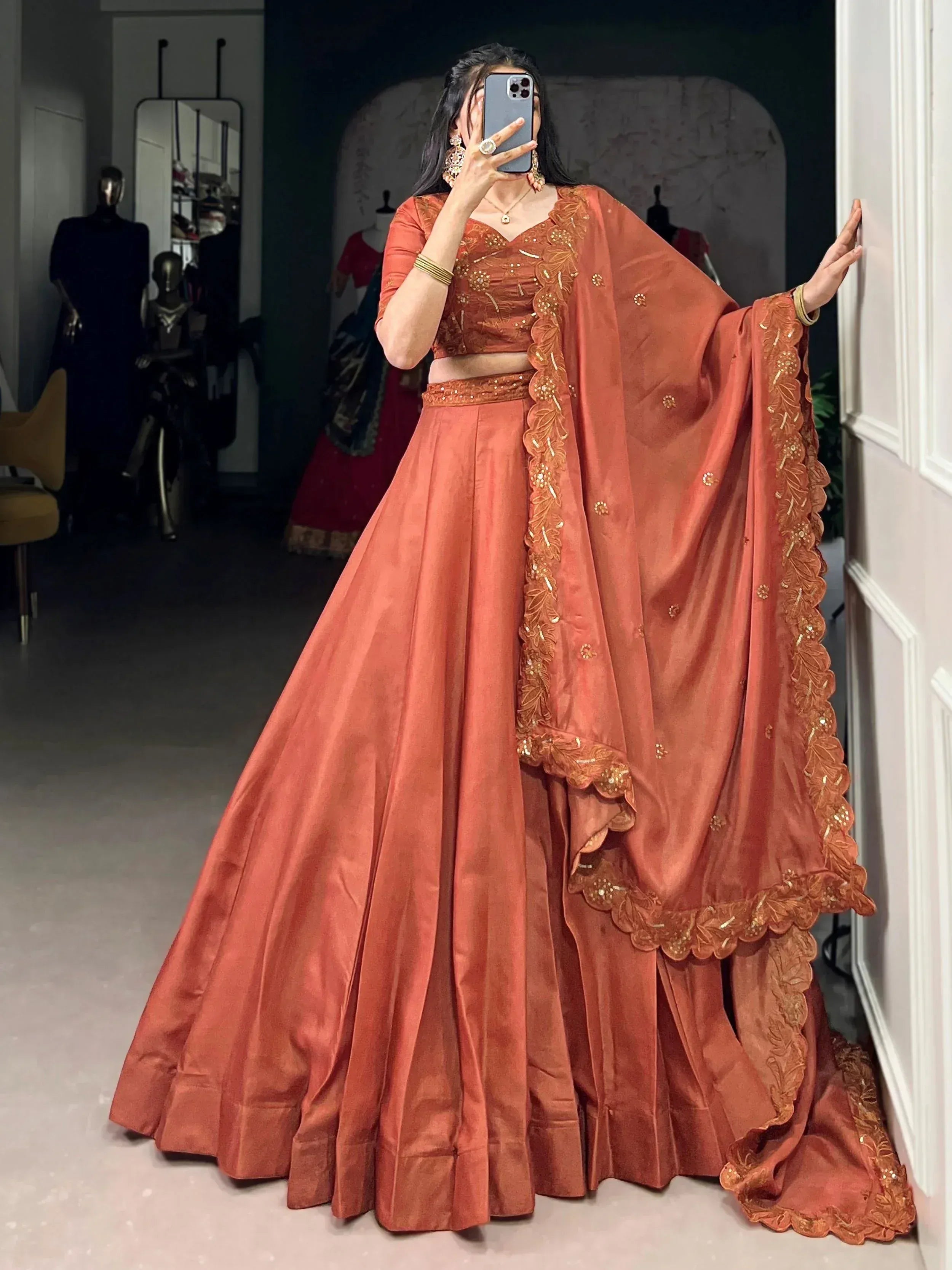 Terracotta lehenga choli with gold embroidery, perfect for Indian weddings and festive occasions.