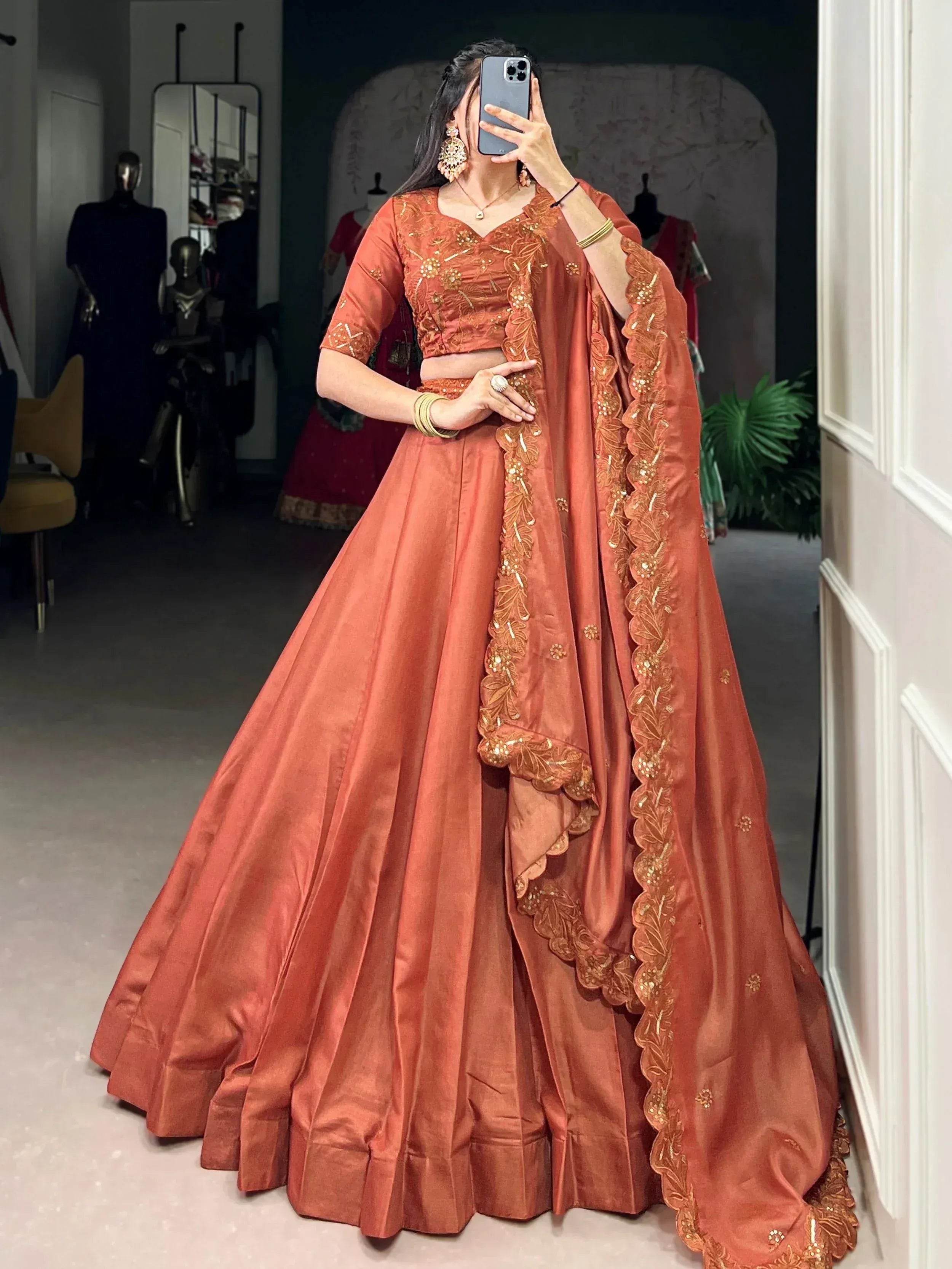 Elegant terracotta lehenga choli with gold embroidery, perfect for Indian ethnic wear