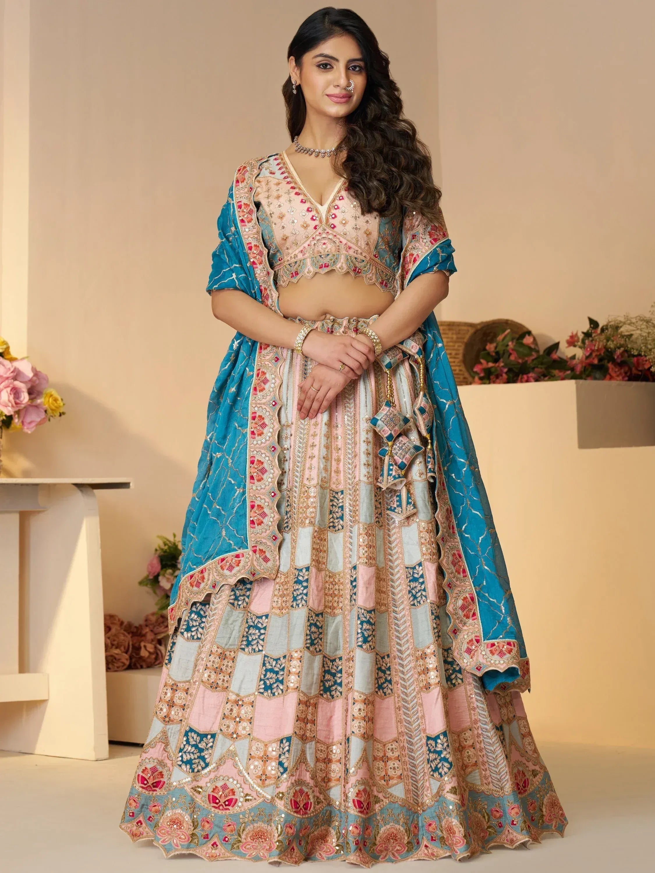 Designer lehenga choli with pink and blue patchwork, floral embroidery, and mirror work for Indian ethnic wear
