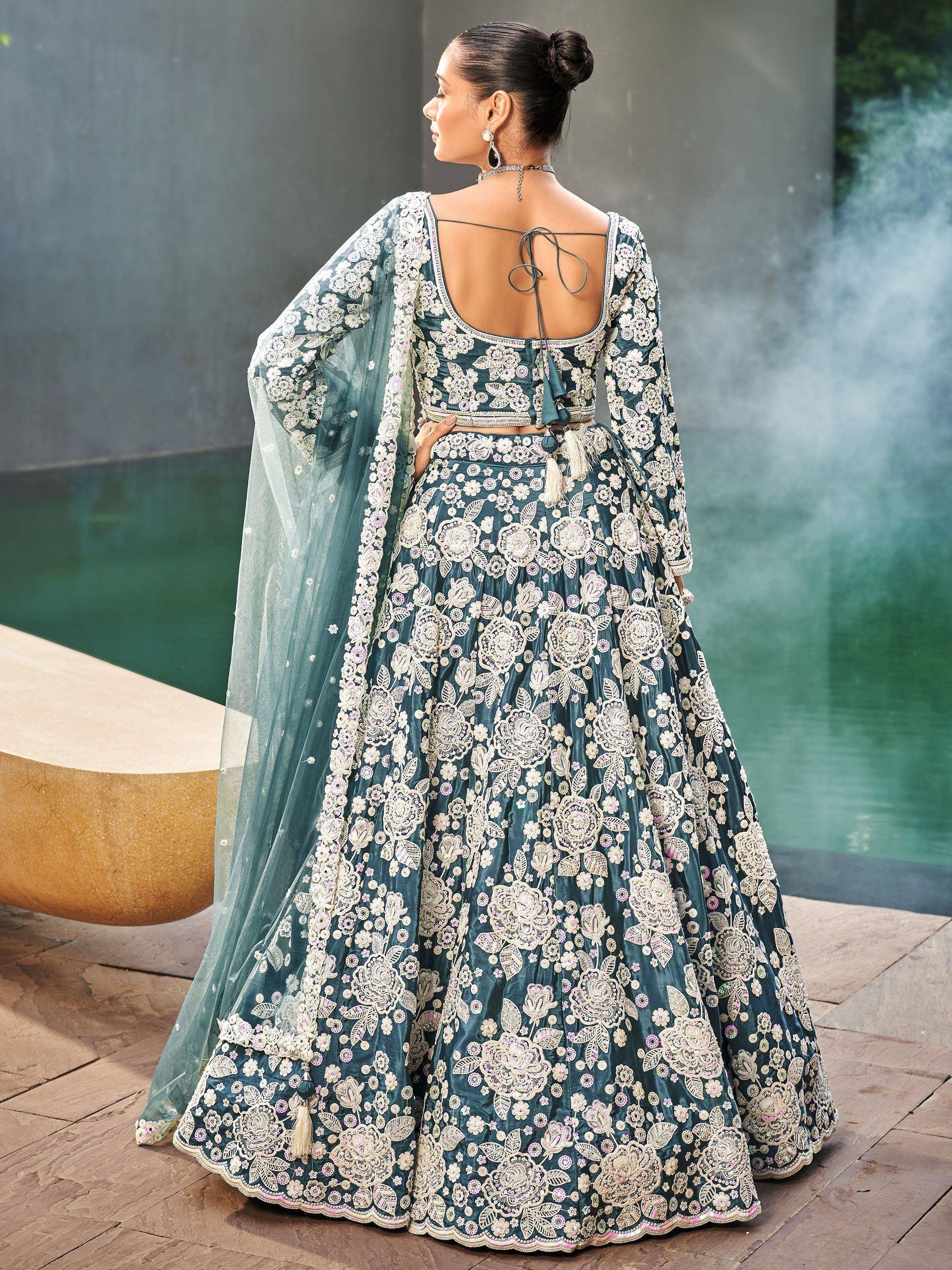 Teal floral embroidered lehenga choli with sheer dupatta, back view near pool