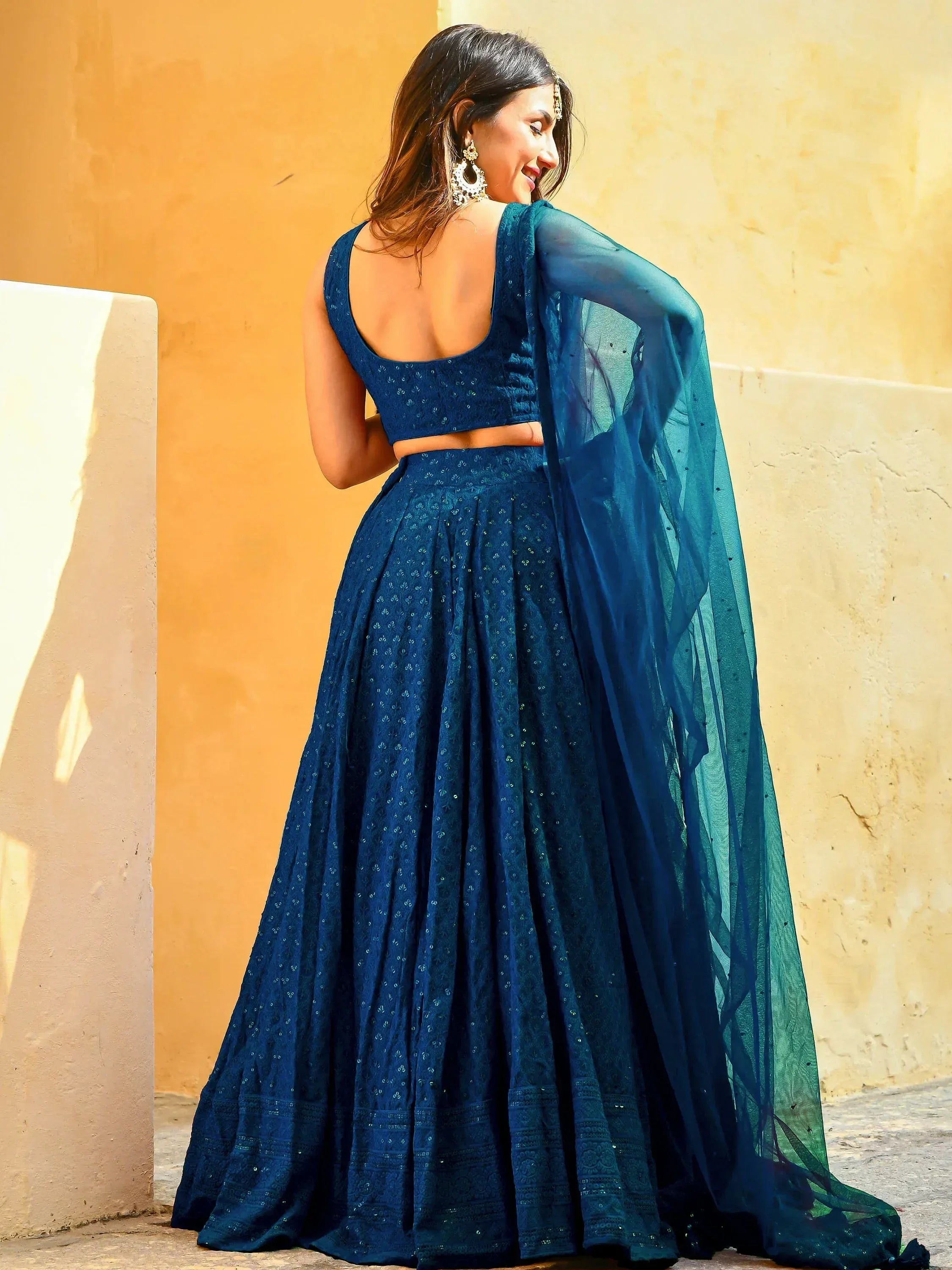 Woman in blue embroidered lehenga choli with sheer dupatta, Indian ethnic wear