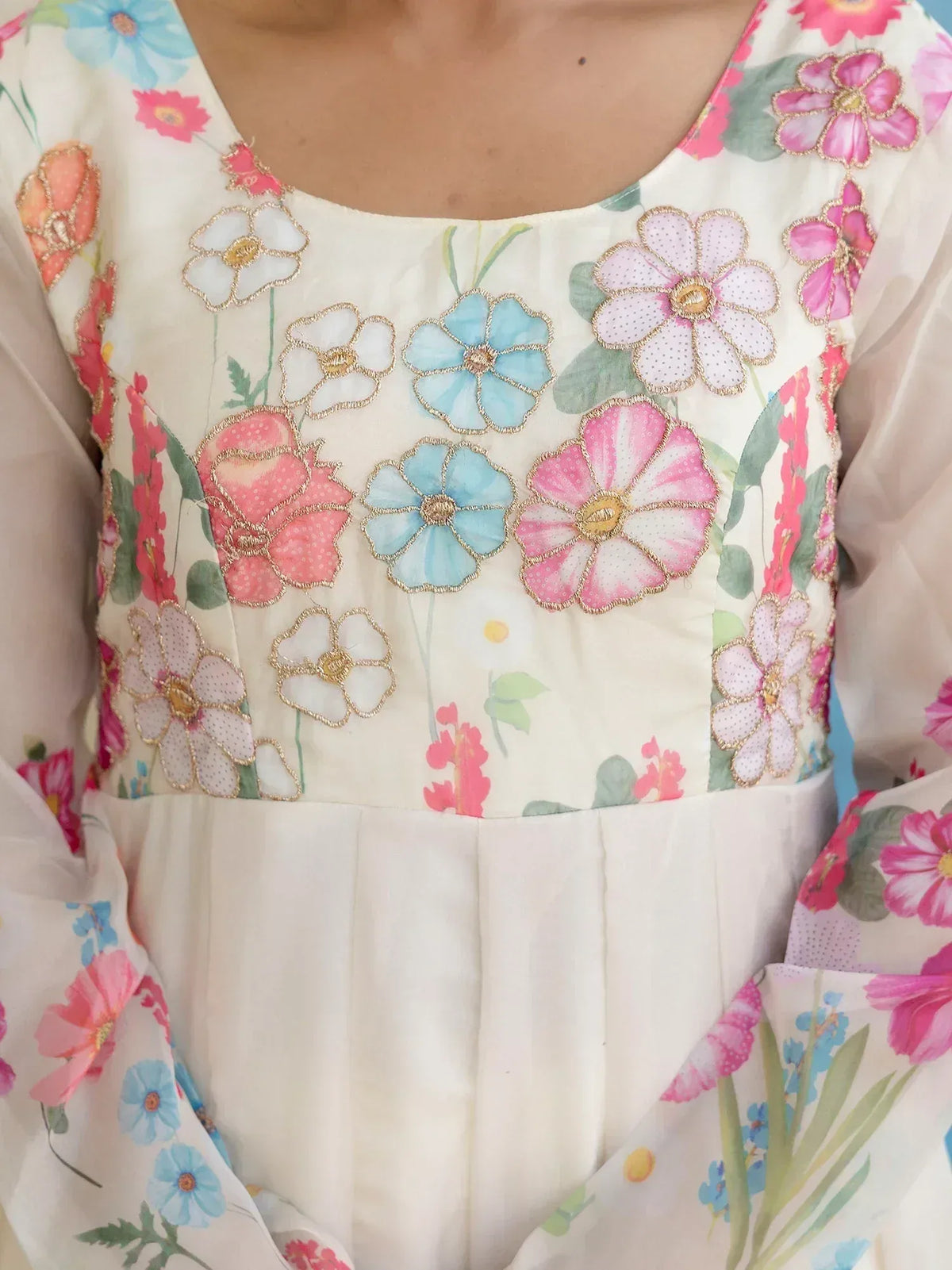 Floral embroidered ethnic gown with pink and blue flowers, gold detailing, and pleated waist