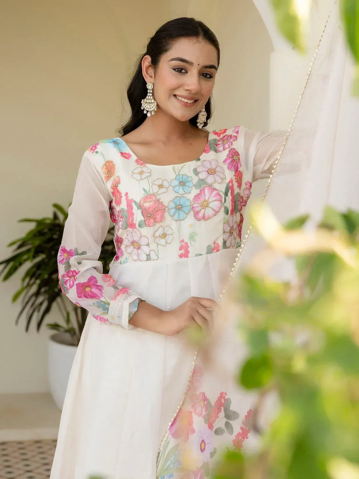 Floral embroidered white ethnic gown with pastel blooms and sheer sleeves
