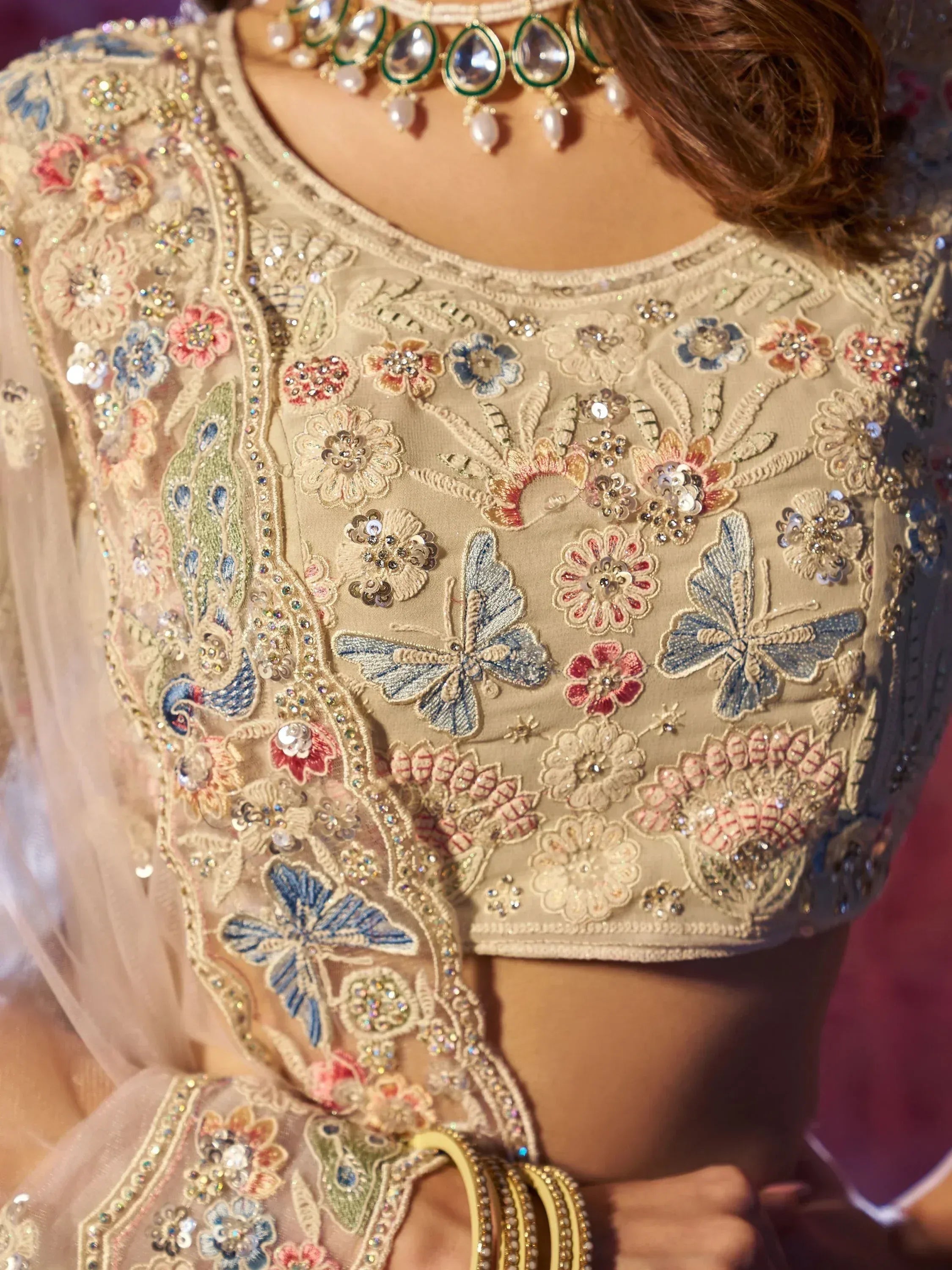 Designer lehenga choli with floral and butterfly embroidery, perfect for Indian ethnic wear occasions.