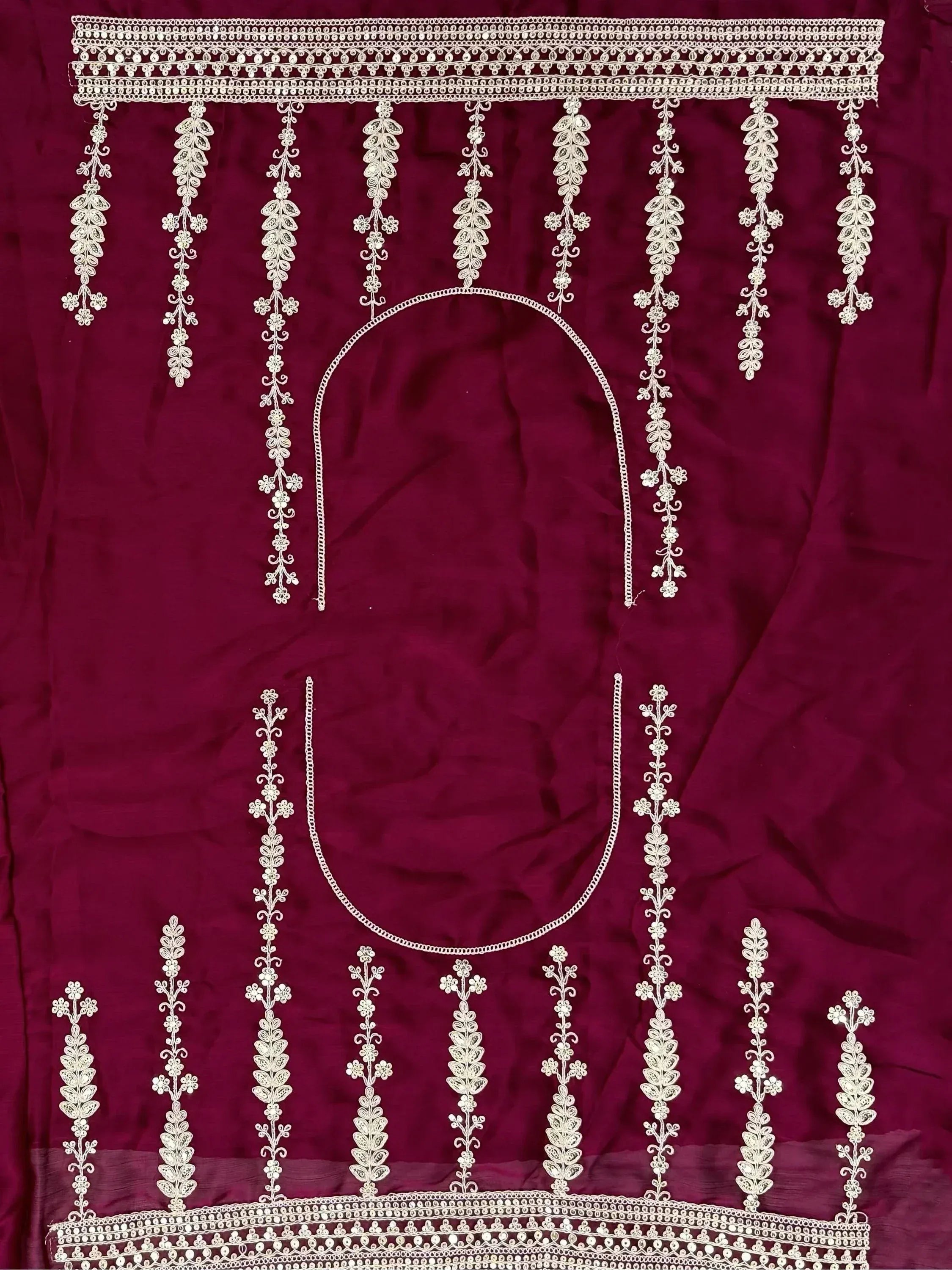 Maroon ethnic blouse with intricate white floral embroidery and scalloped neckline detailing