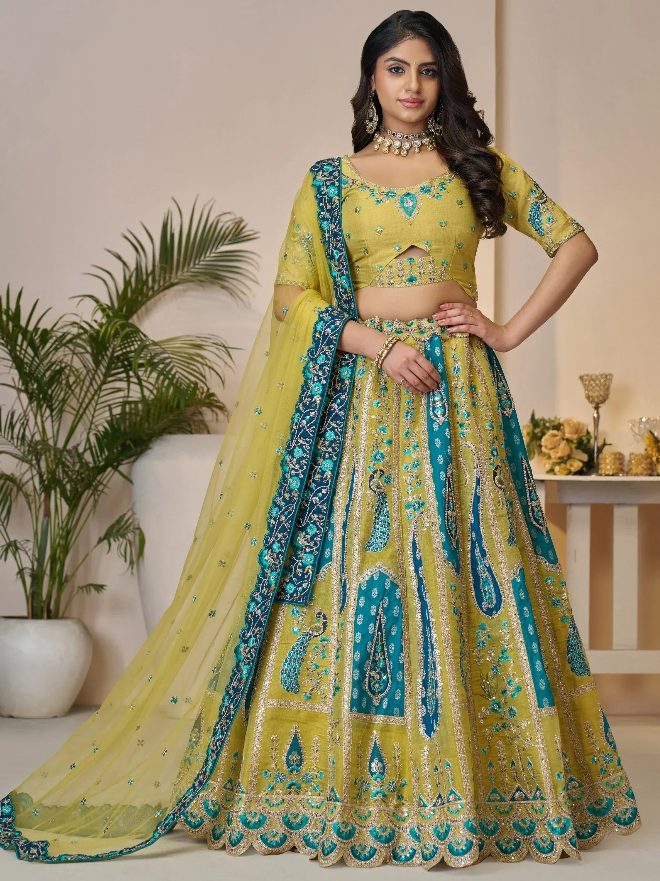 Yellow and teal embroidered lehenga choli with peacock motifs, perfect for Indian ethnic wear events