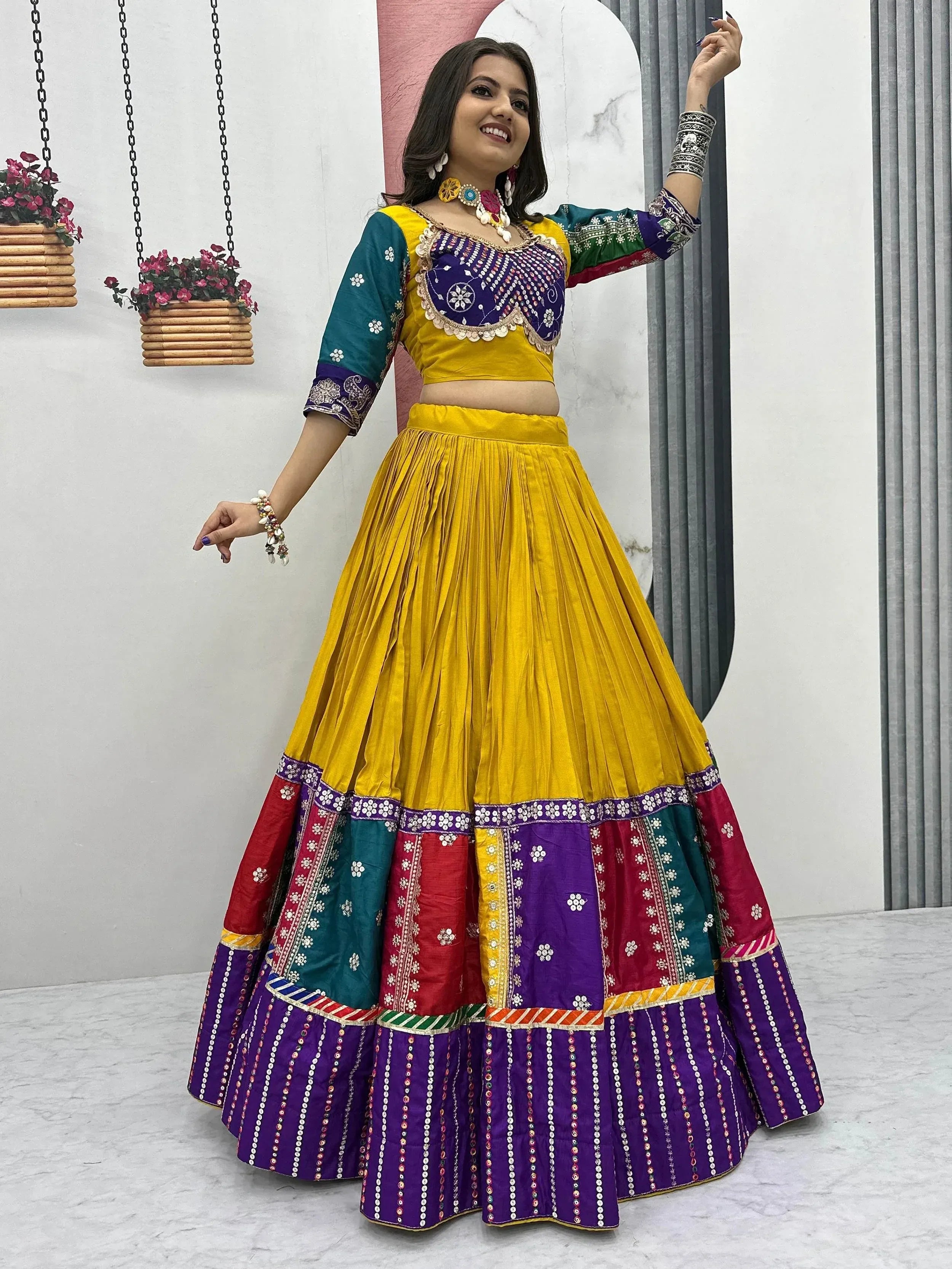 Vibrant yellow and multicolor embroidered lehenga choli with mirror work, perfect for Indian ethnic occasions.