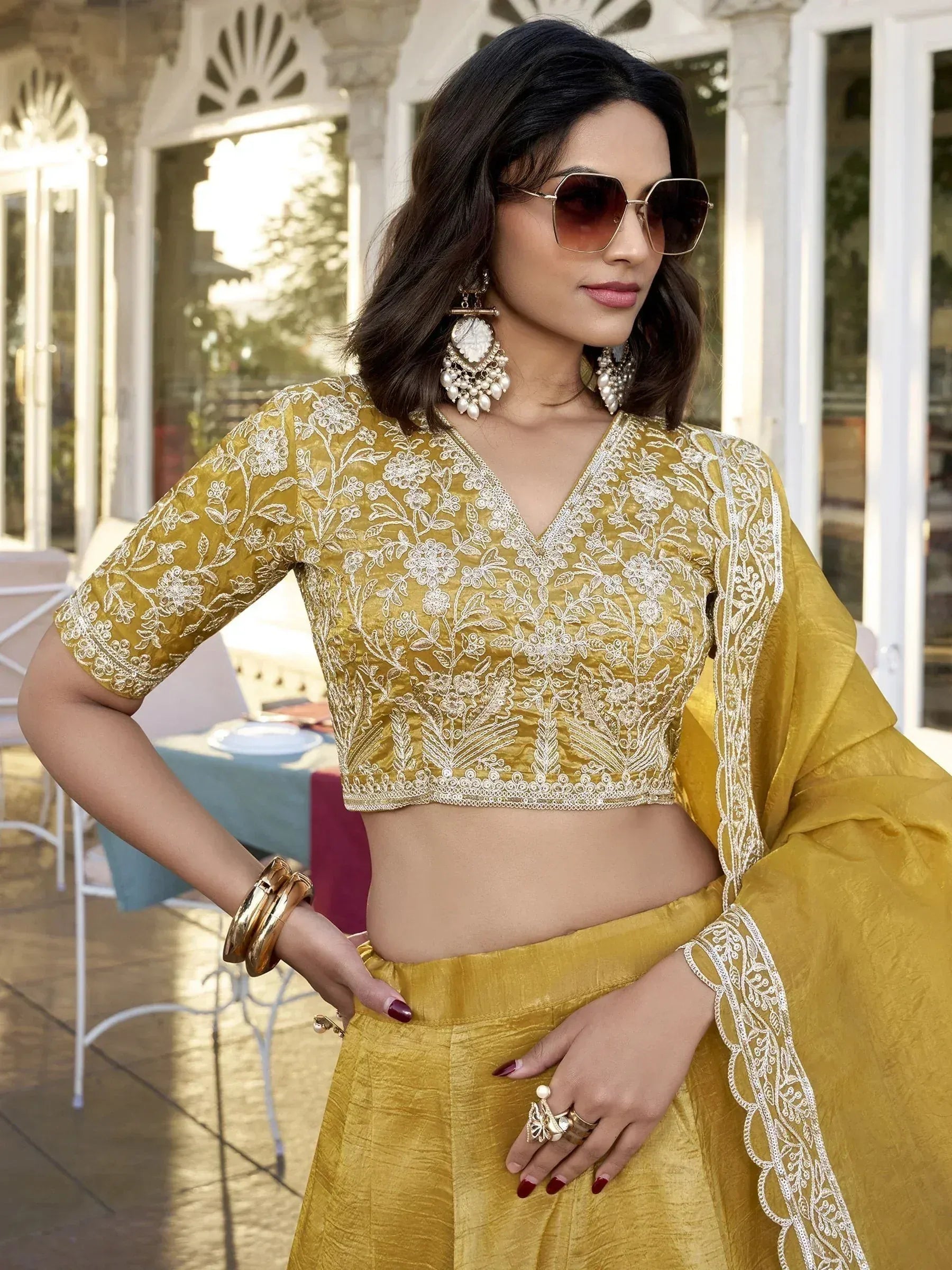Mustard yellow embroidered lehenga choli with floral detailing, perfect for Indian ethnic wear occasions.