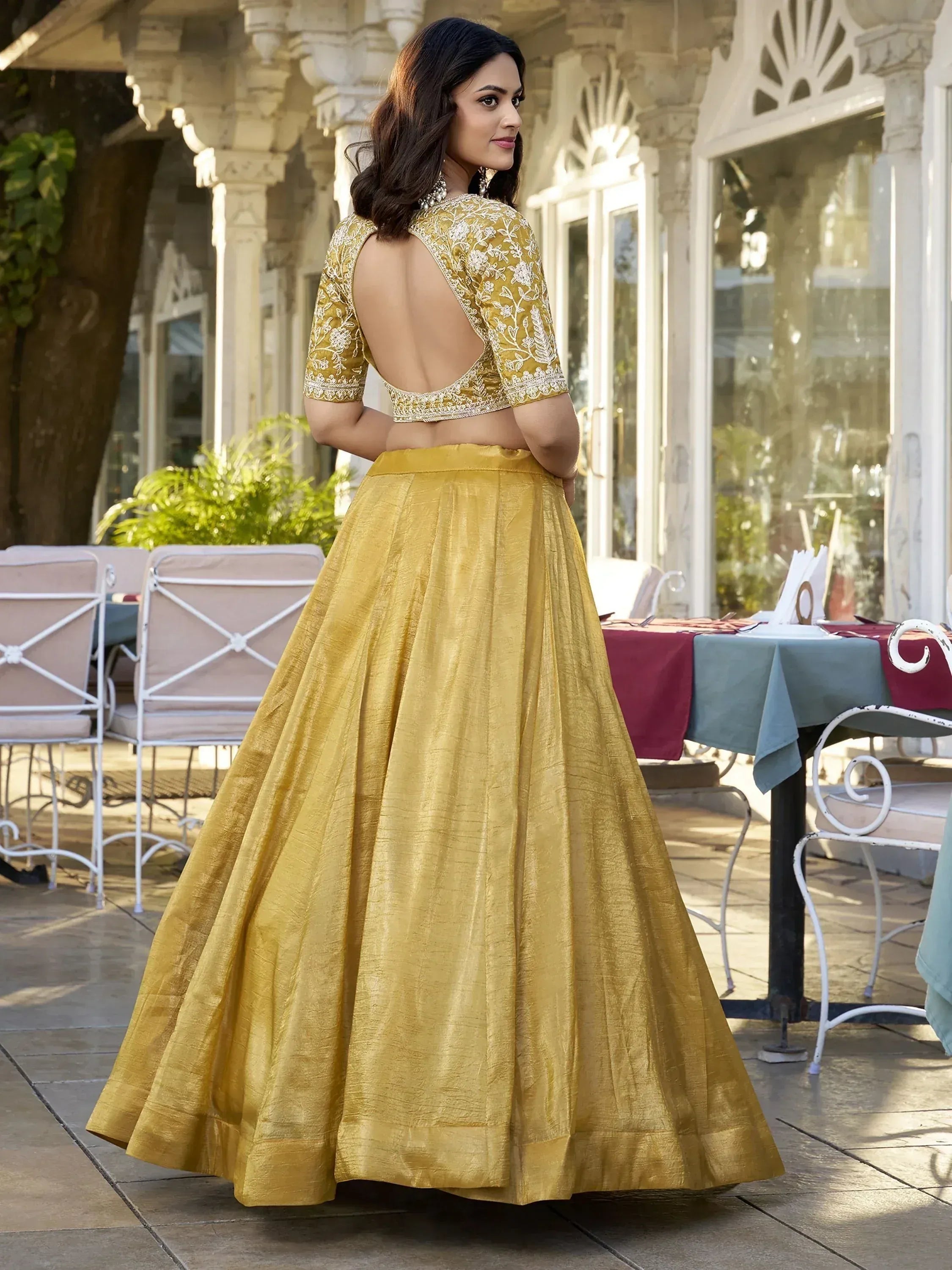 Yellow embroidered lehenga choli with open back, perfect for Indian ethnic wear occasions