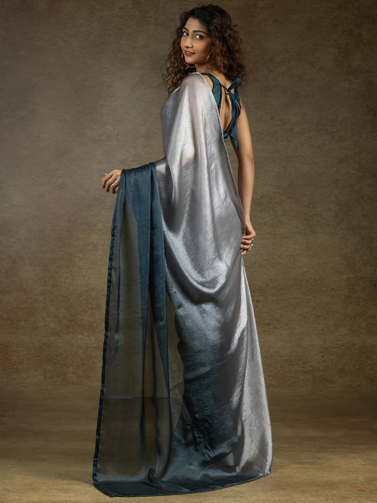 Elegant silver-grey saree with teal border, styled with back-tie blouse for Indian ethnic wear